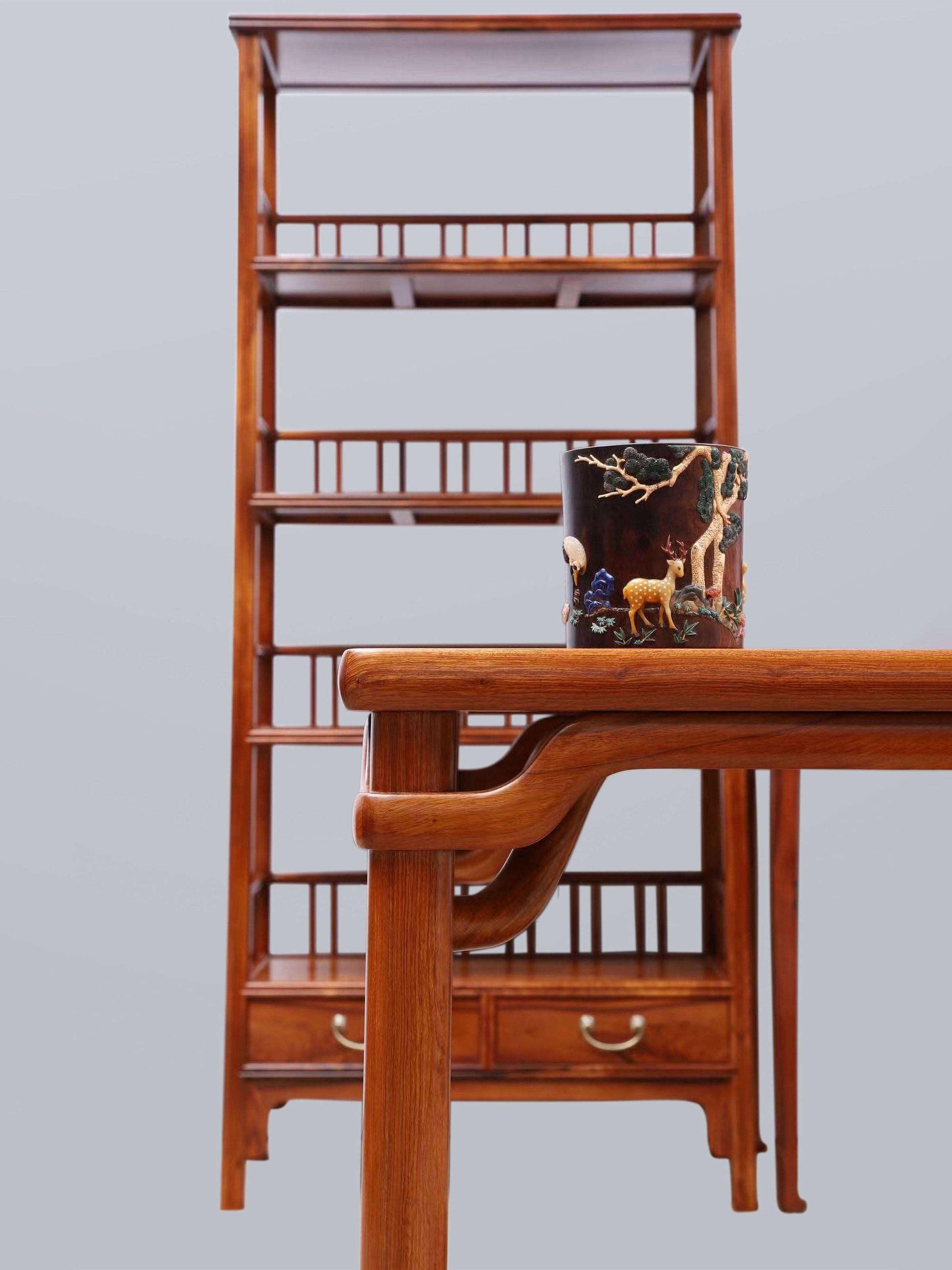 White rosewood branches sparsely sprout from the bottom of the scholar's desk.