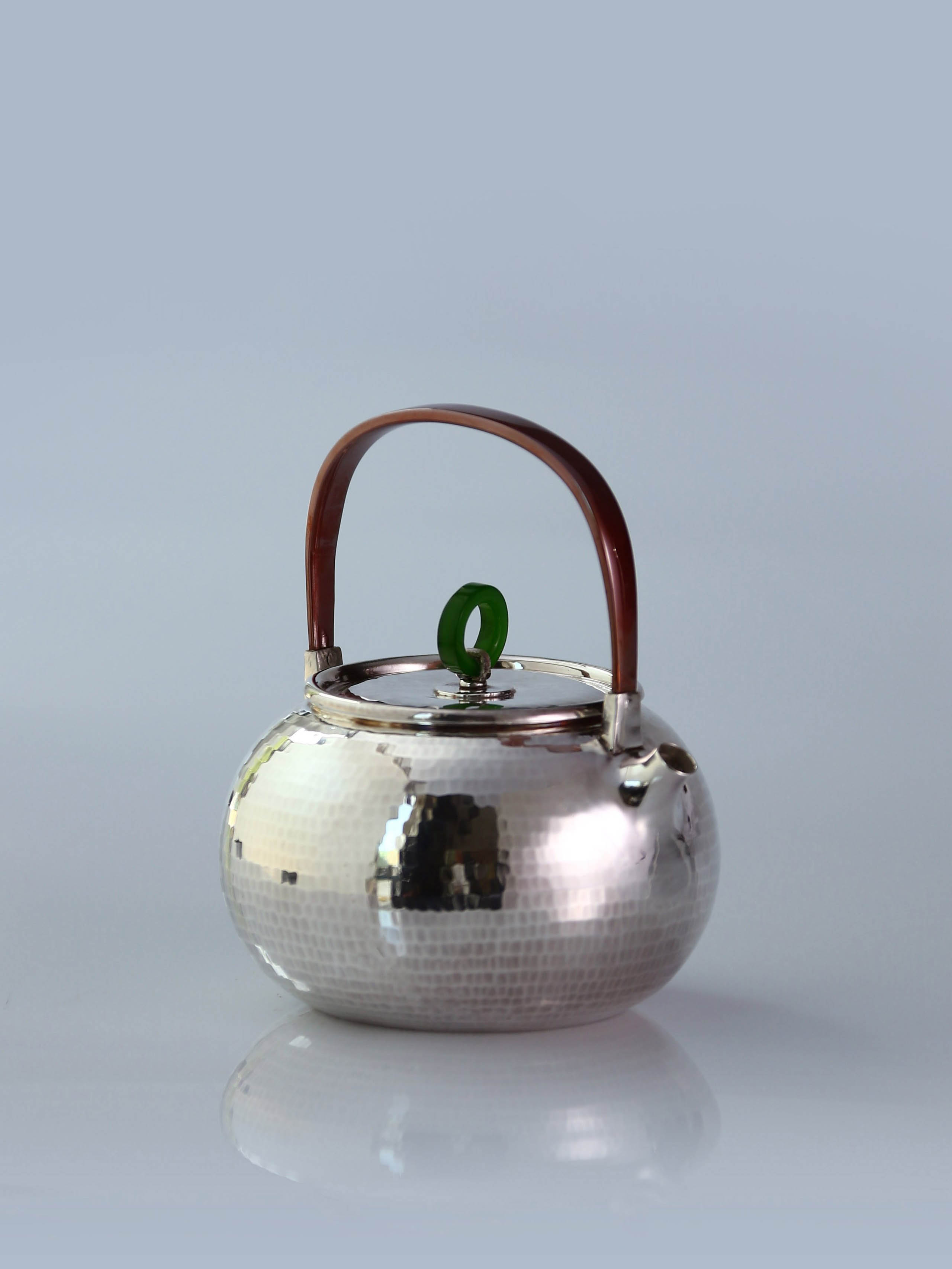 Hammered silver teapot with handle