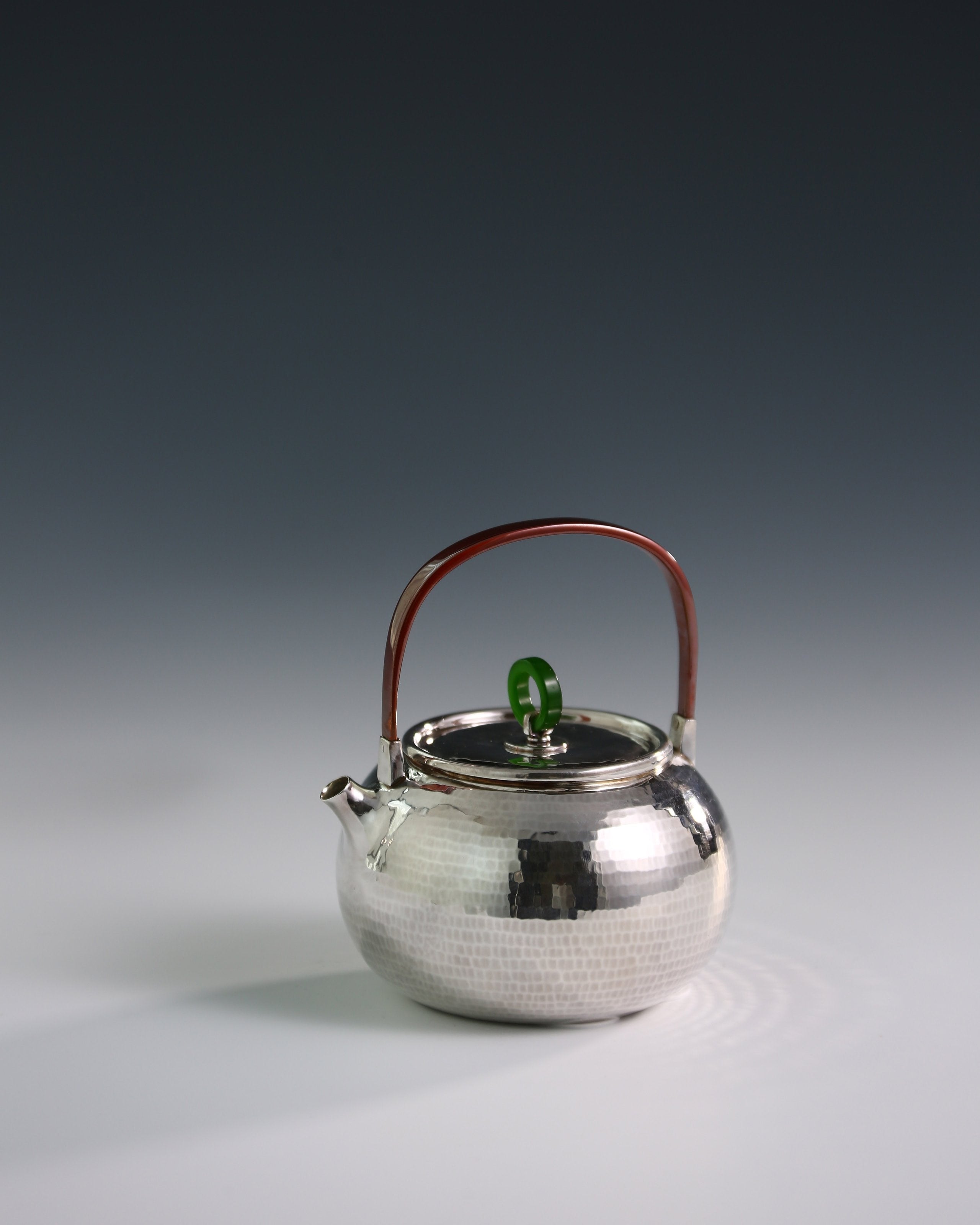 Hammered silver teapot with handle