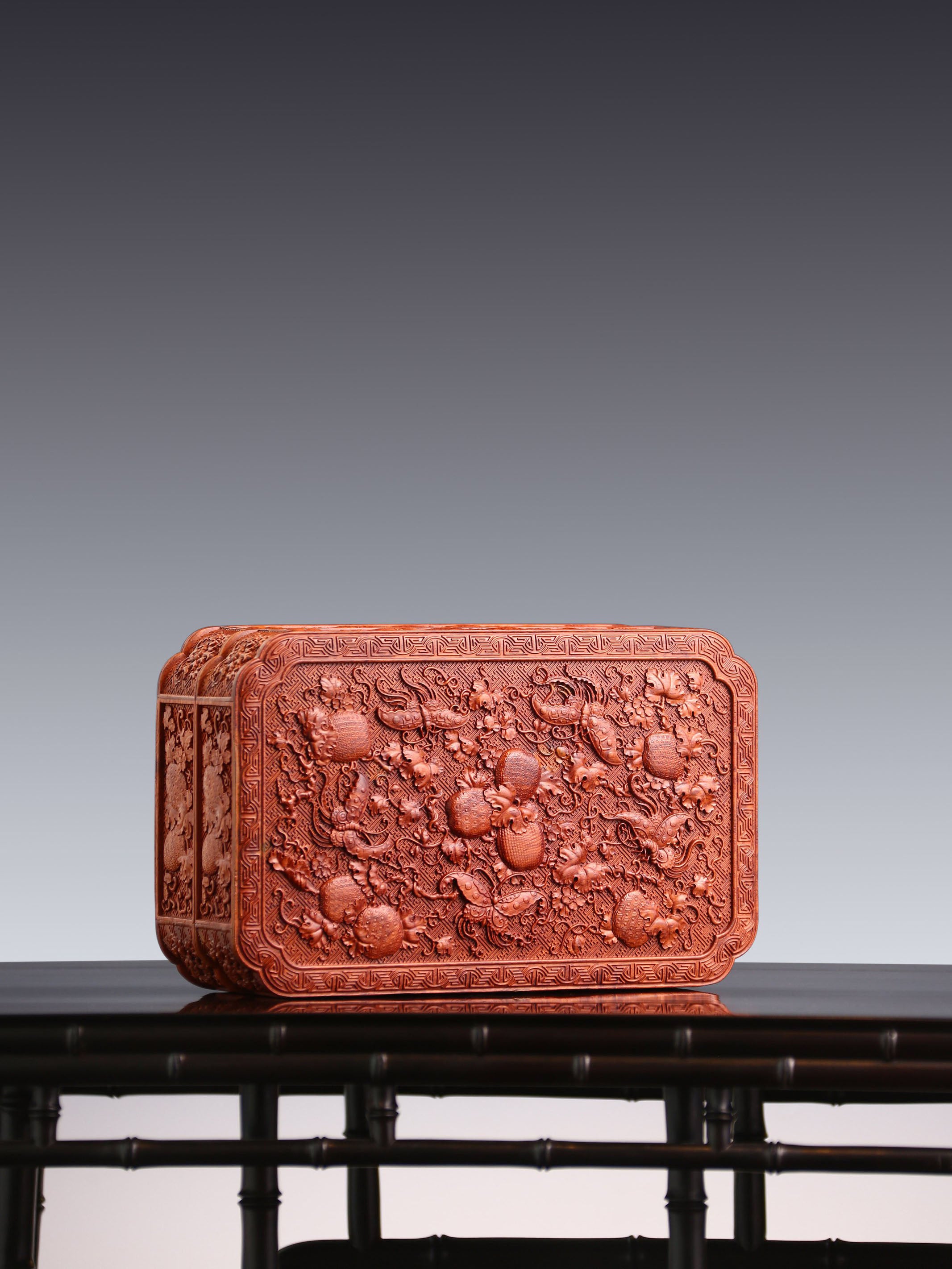 Tea box with full carving of lychee, butterfly, and dragon patterns