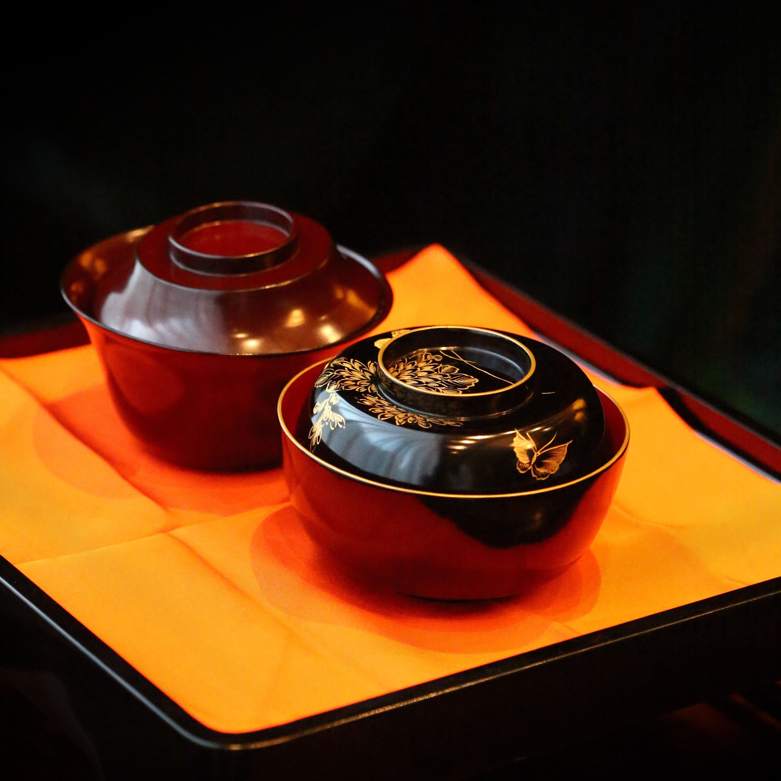 Two lacquered and gold-plated covered bowls