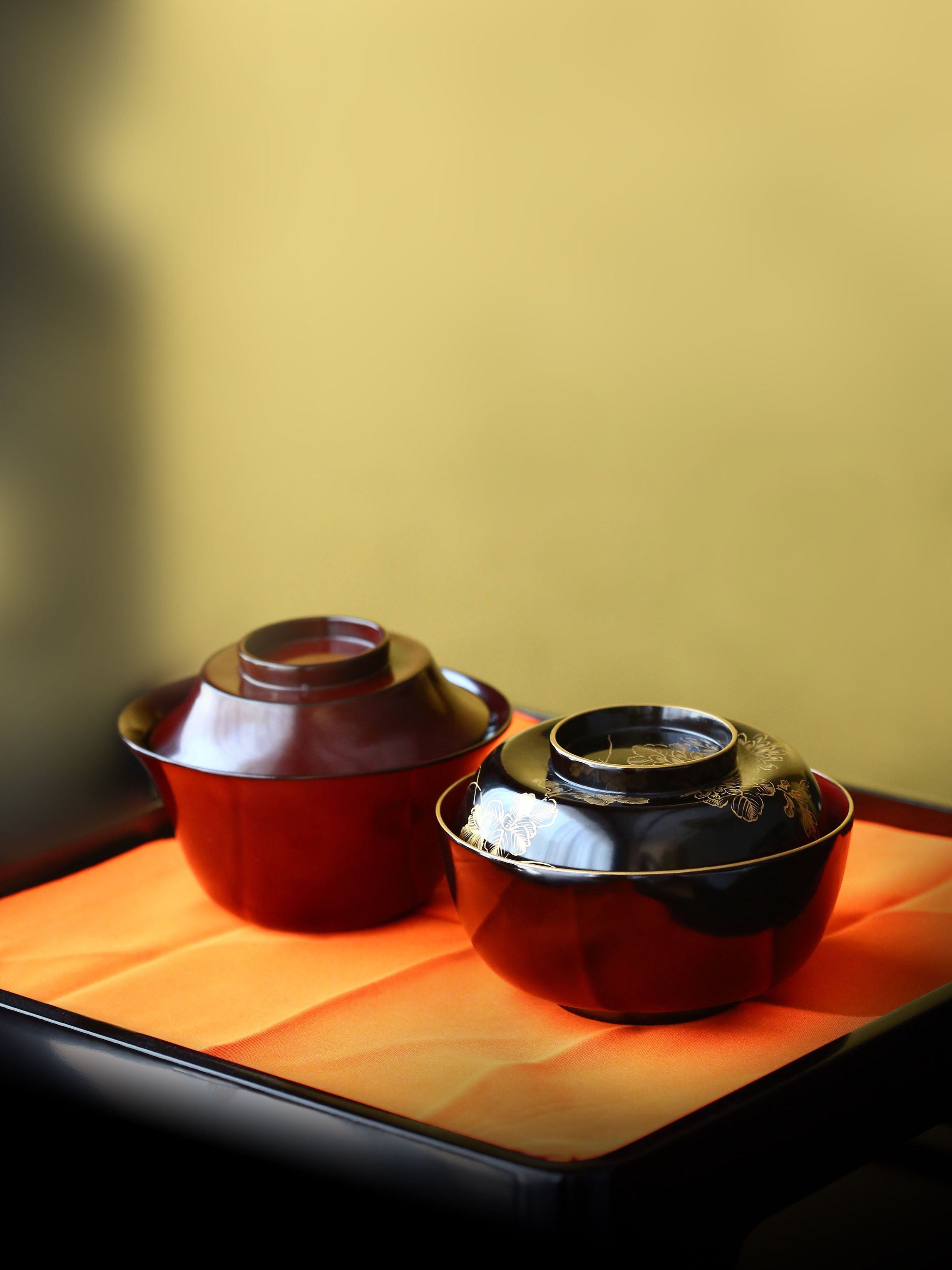 Two lacquered and gold-plated covered bowls