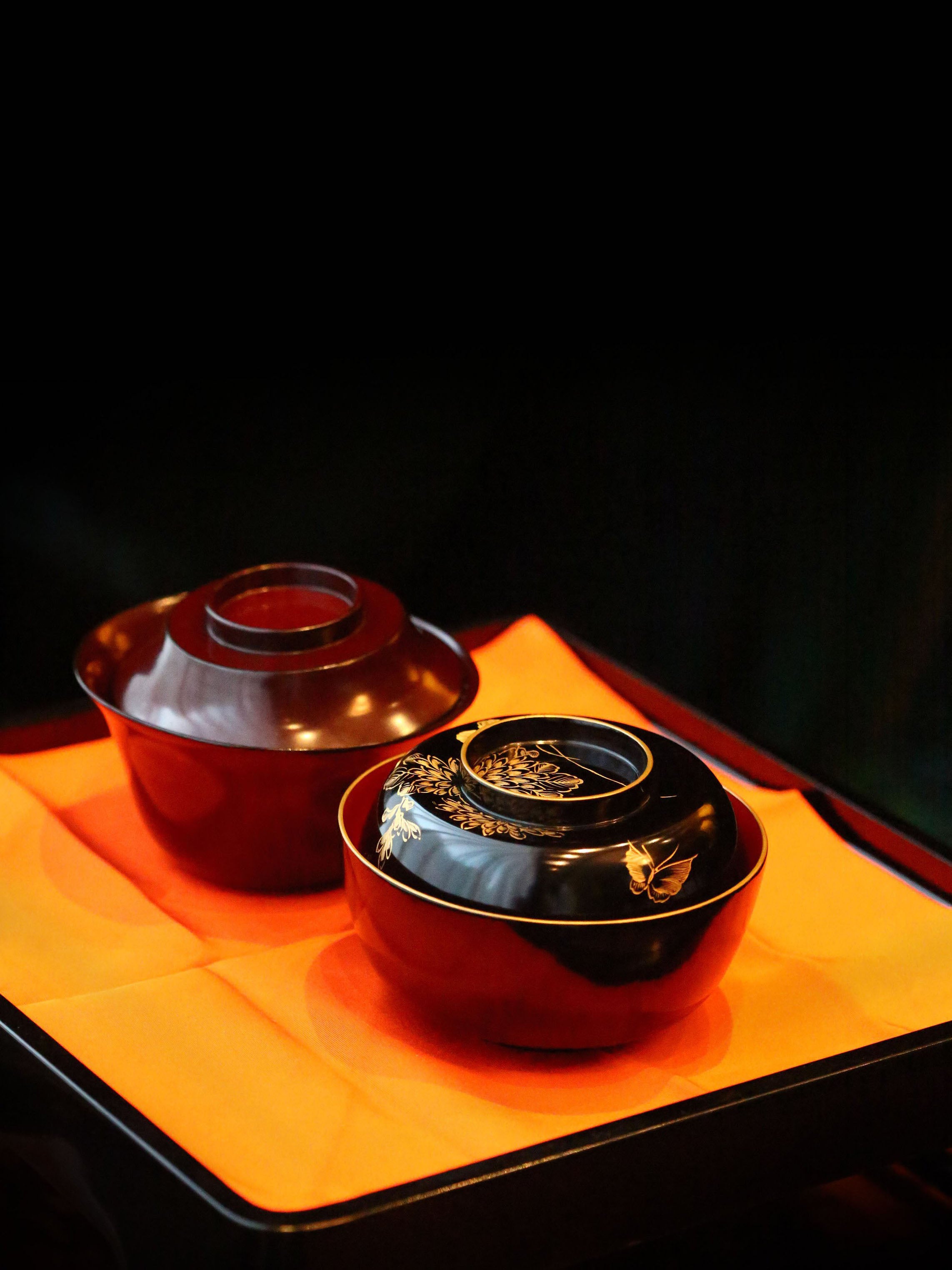 Two lacquered and gold-plated covered bowls