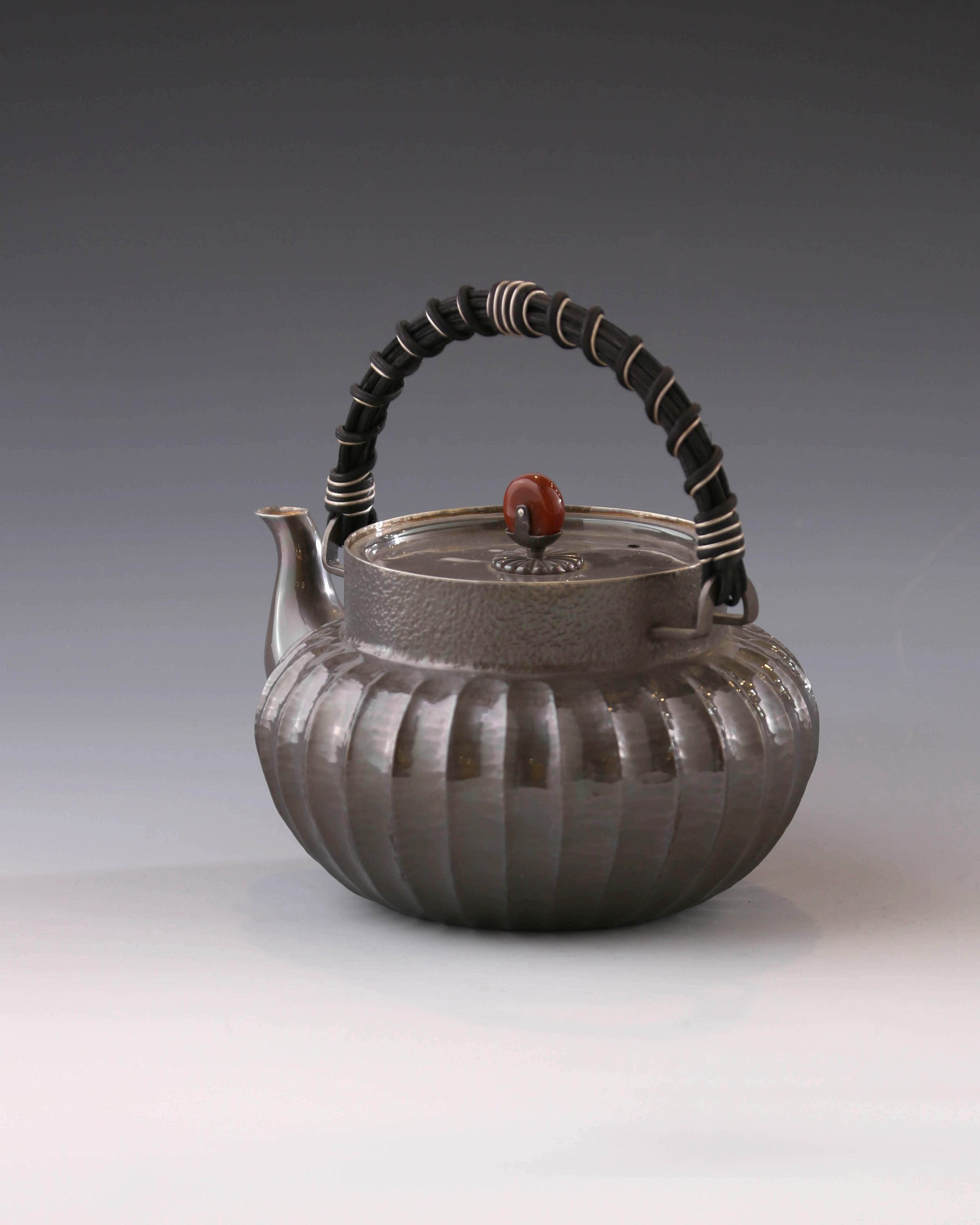 Lantern-shaped silver pot with rattan handle