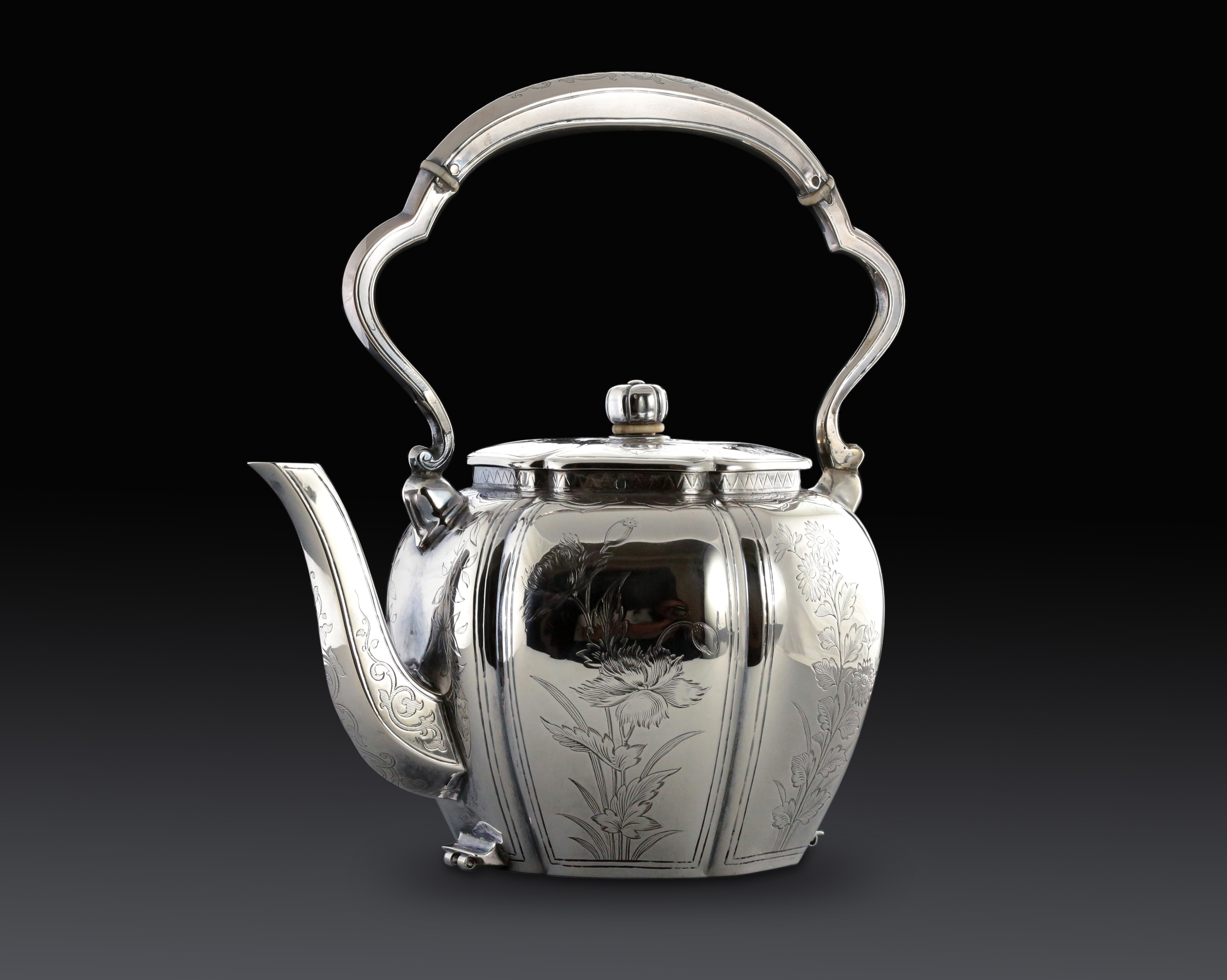 A set of 19th-century French sterling silver tea set featuring a swirling palm leaf pattern.