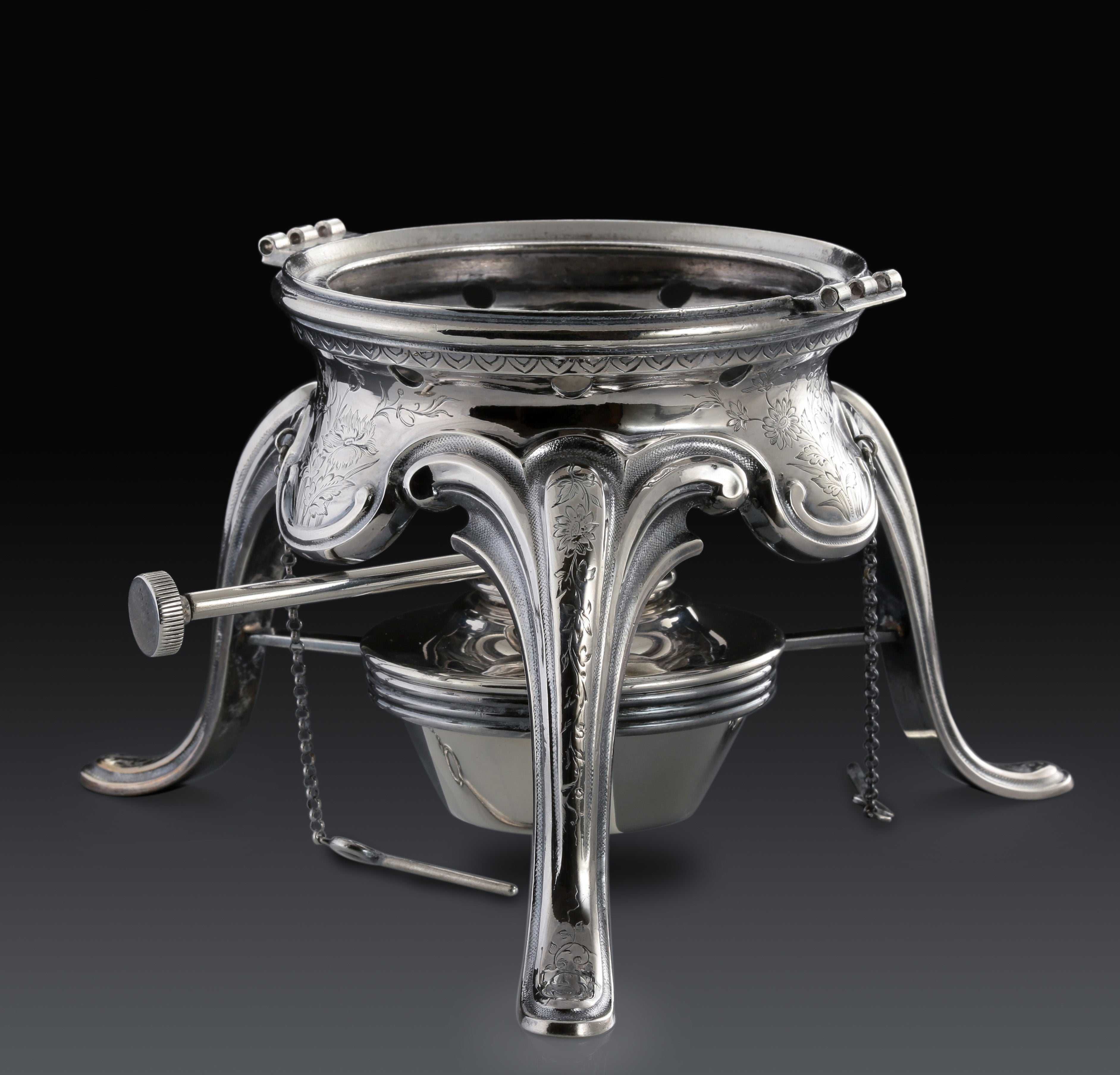 A set of 19th-century French sterling silver tea set featuring a swirling palm leaf pattern.