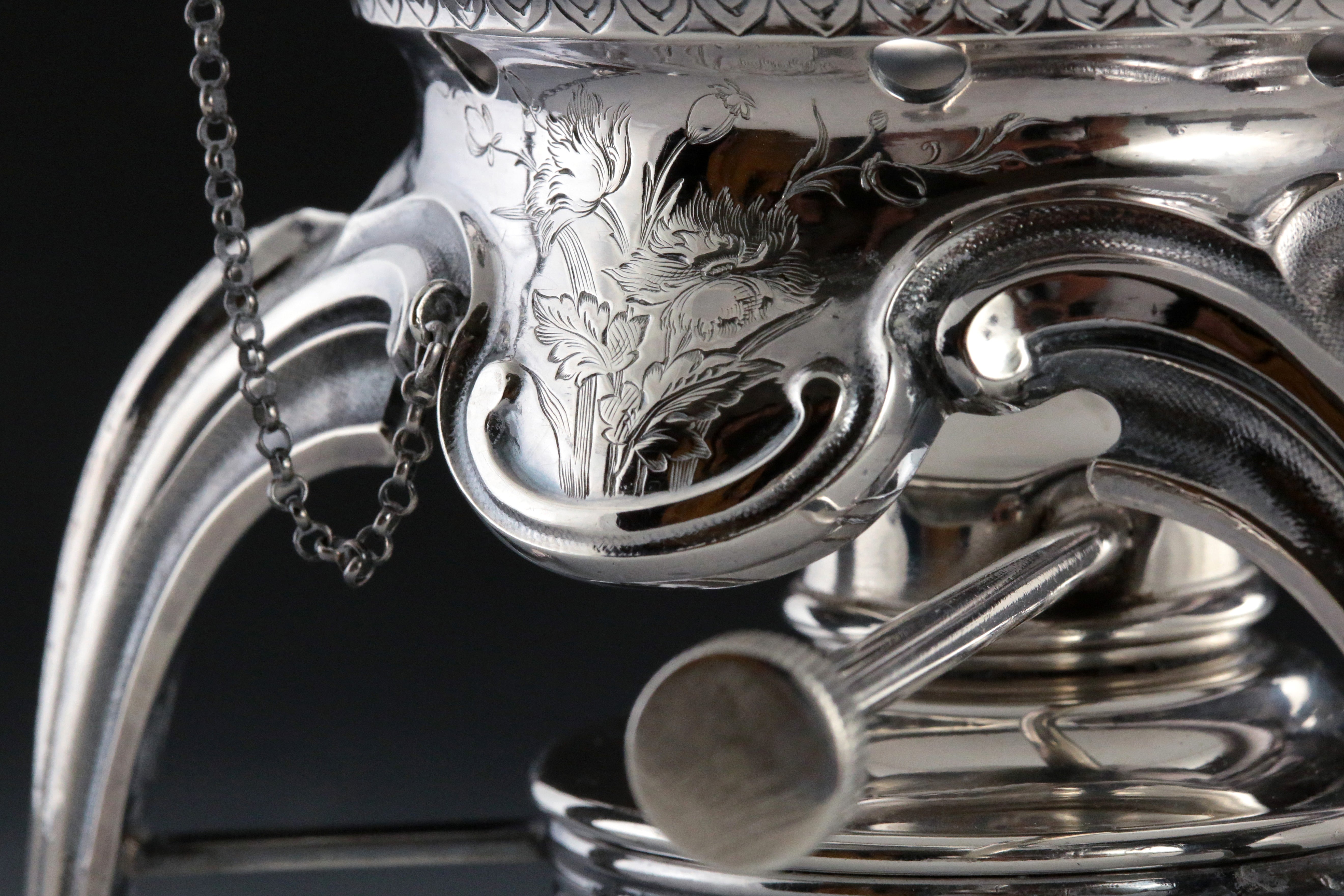 A set of 19th-century French sterling silver tea set featuring a swirling palm leaf pattern.