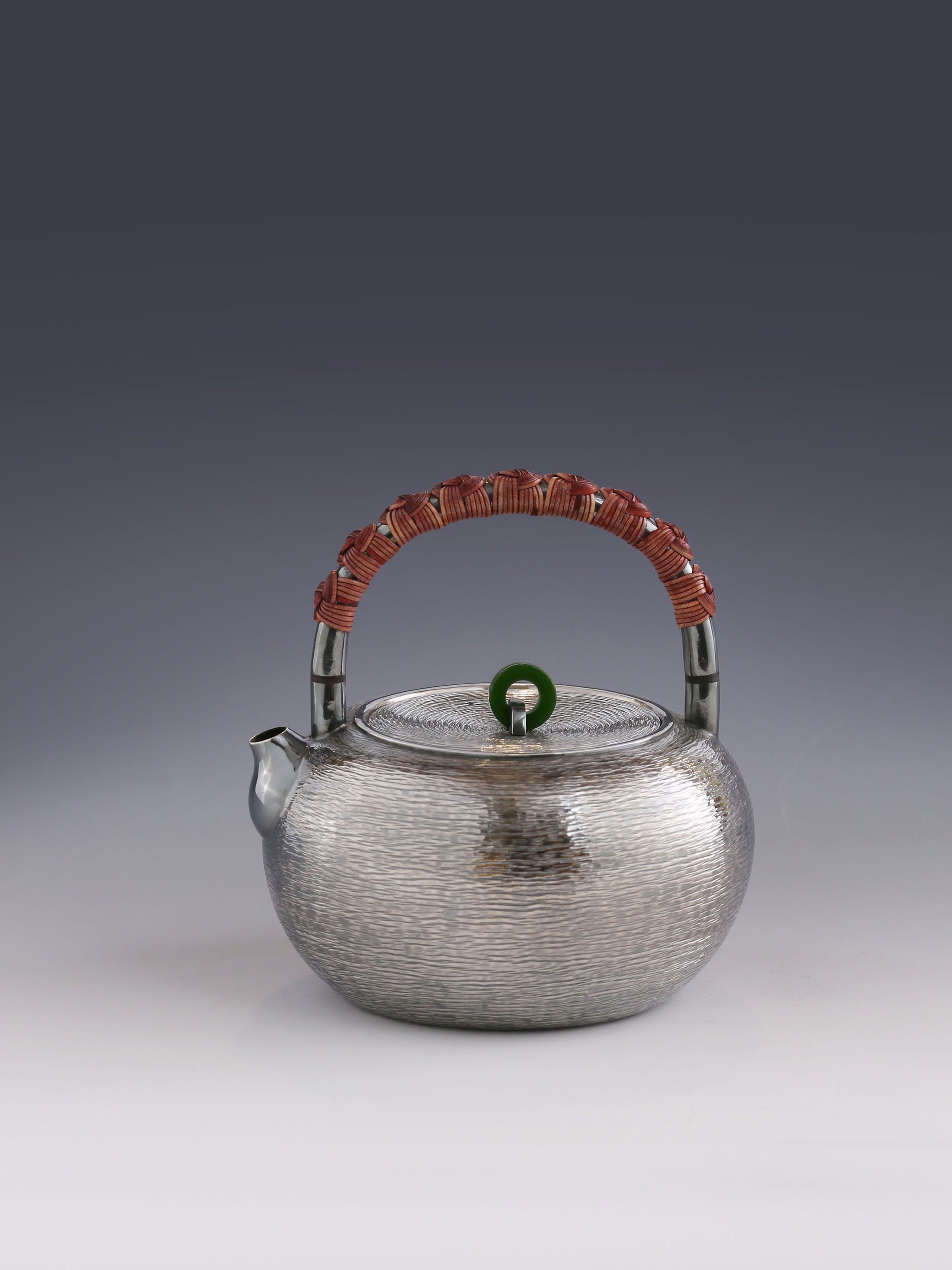 Silver teapot with horizontal stripes and heat insulation handle