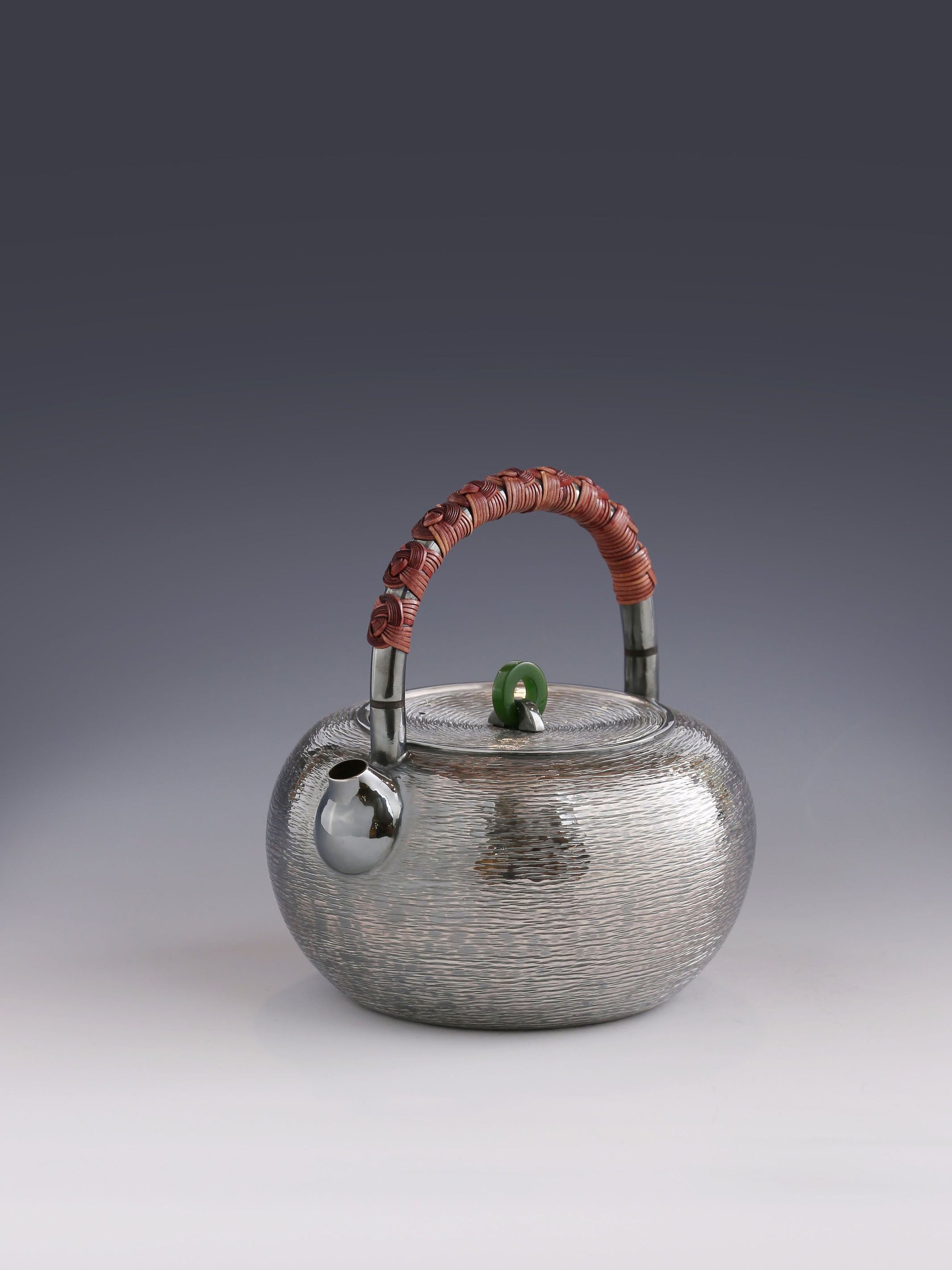 Silver teapot with horizontal stripes and heat insulation handle