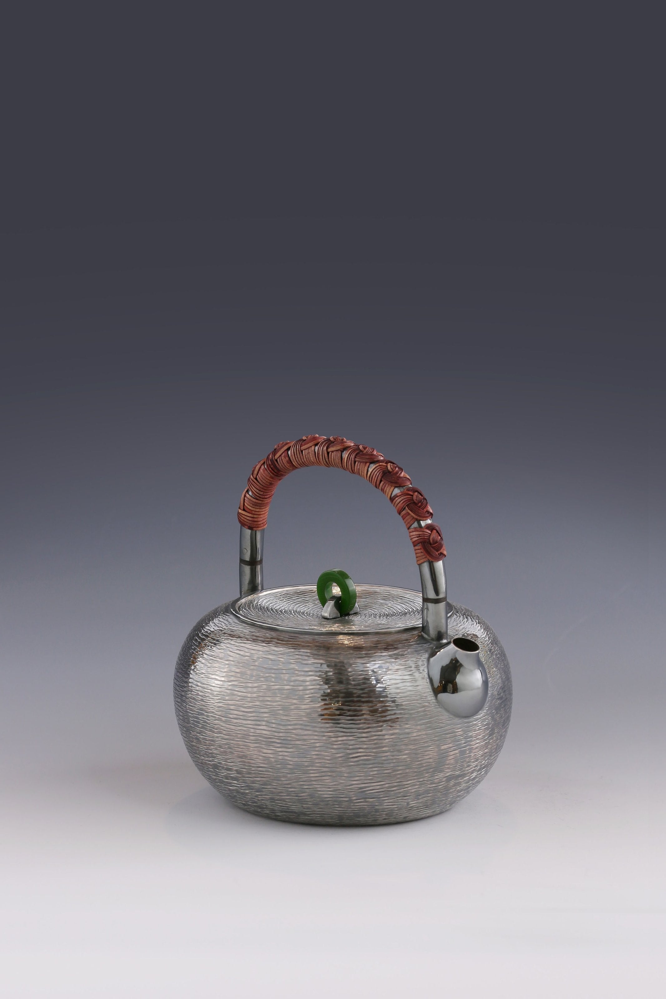 Silver teapot with horizontal stripes and heat insulation handle