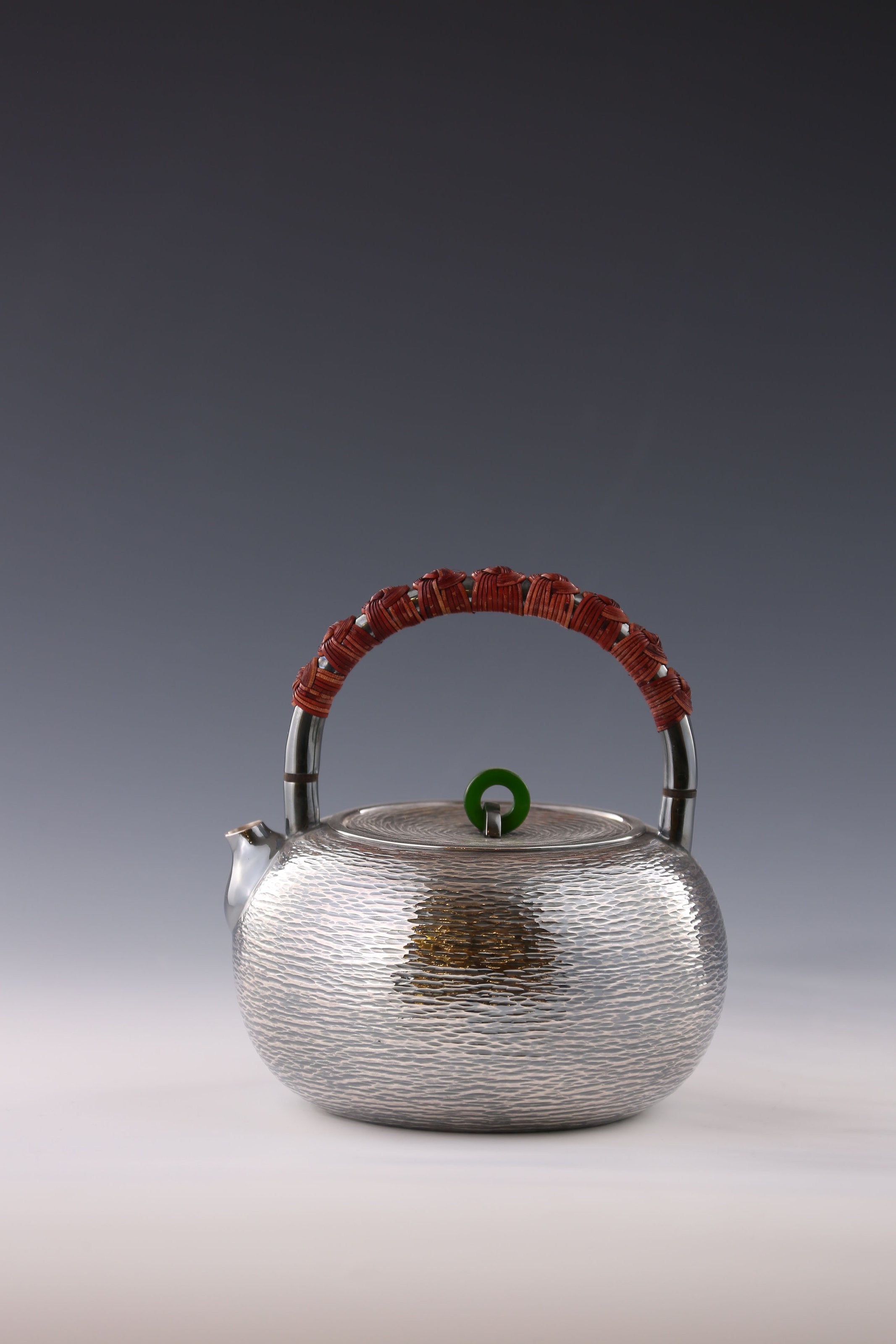 Silver teapot with horizontal stripes and heat insulation handle