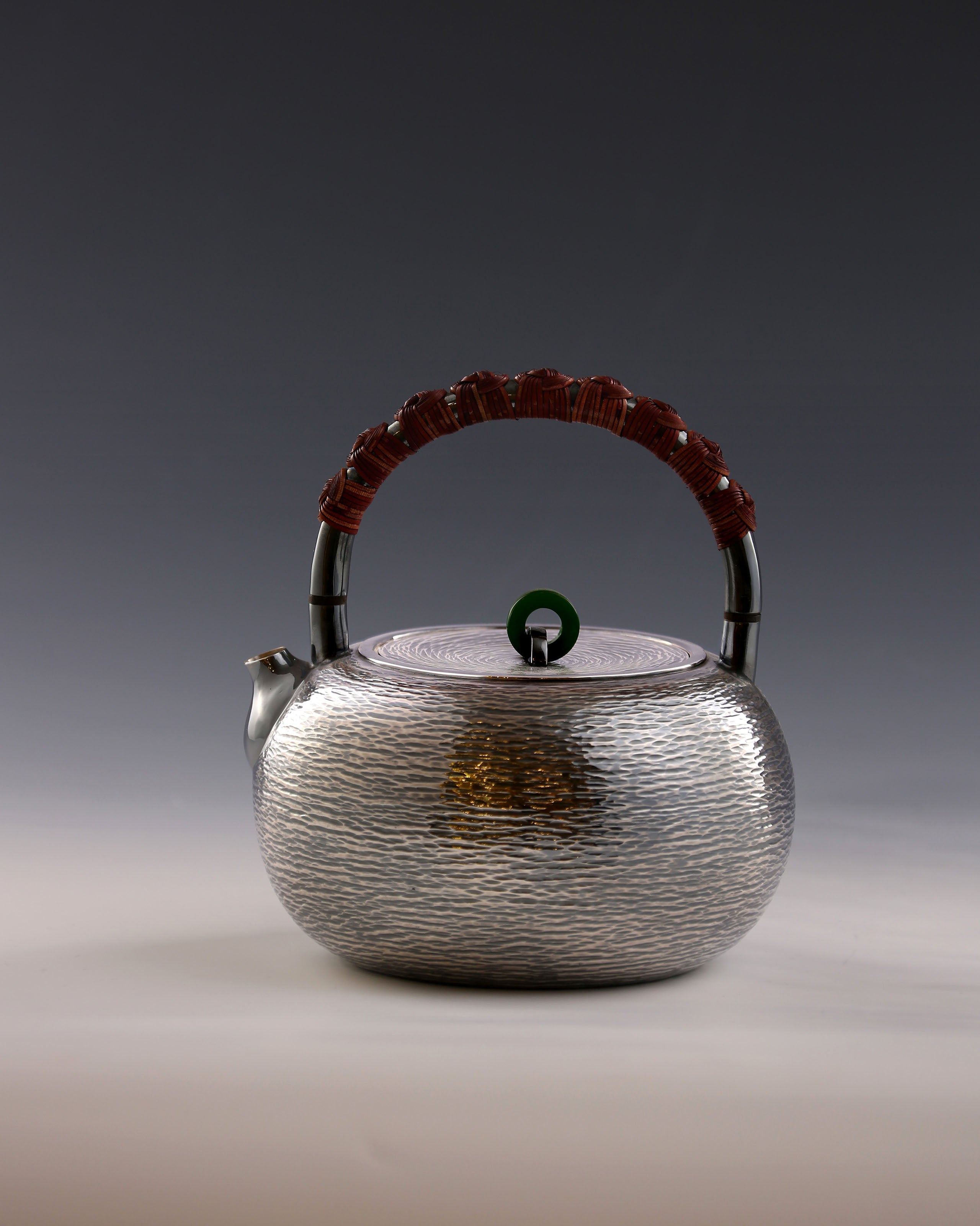 Silver teapot with horizontal stripes and heat insulation handle