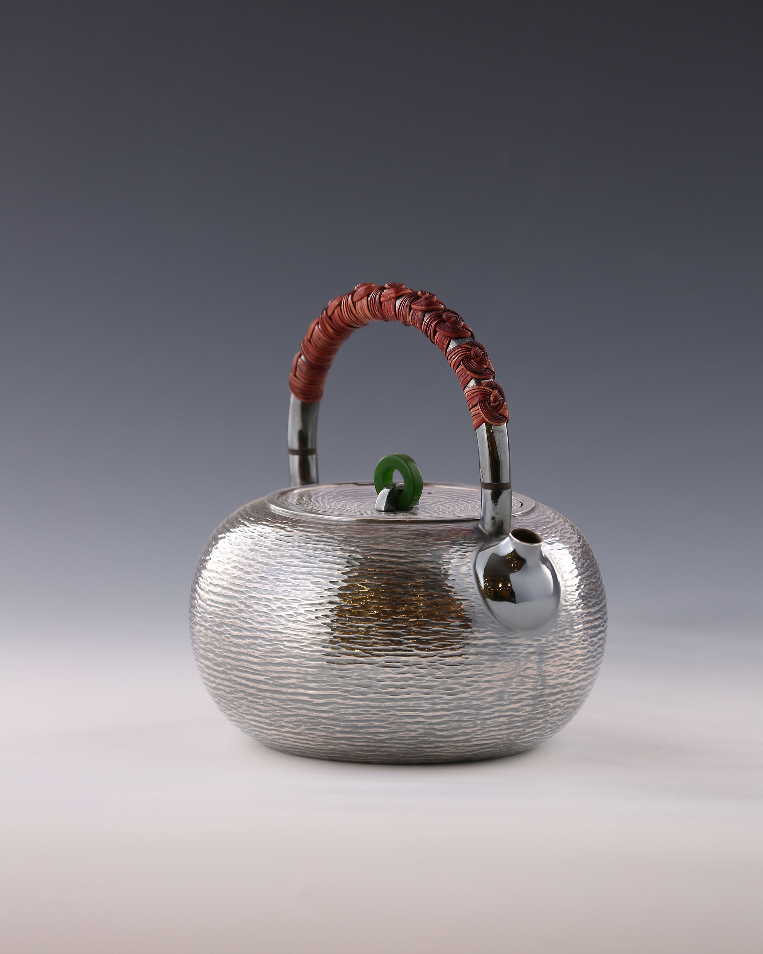 Silver teapot with horizontal stripes and heat insulation handle