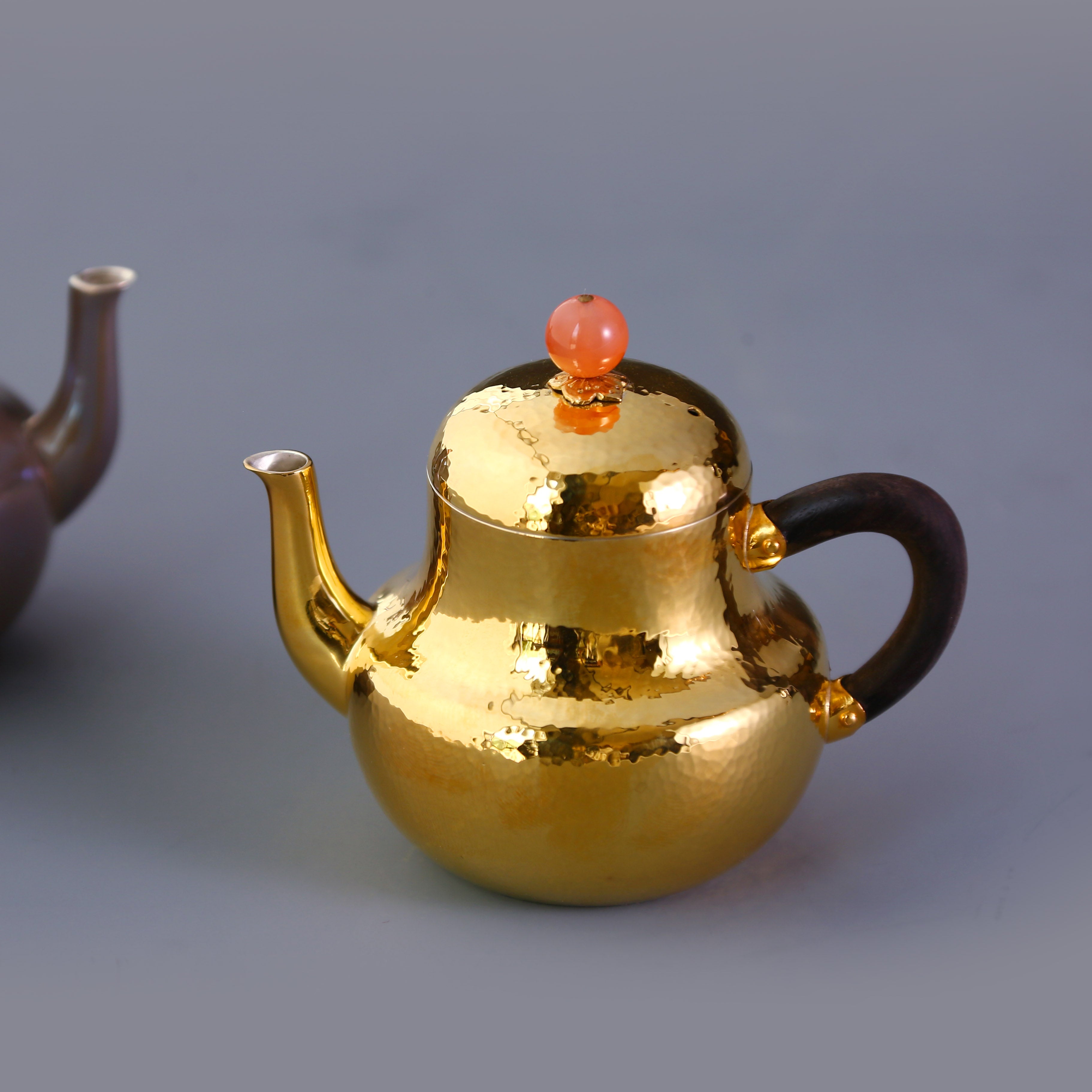 A pair of red-topped Siting sterling silver teapots