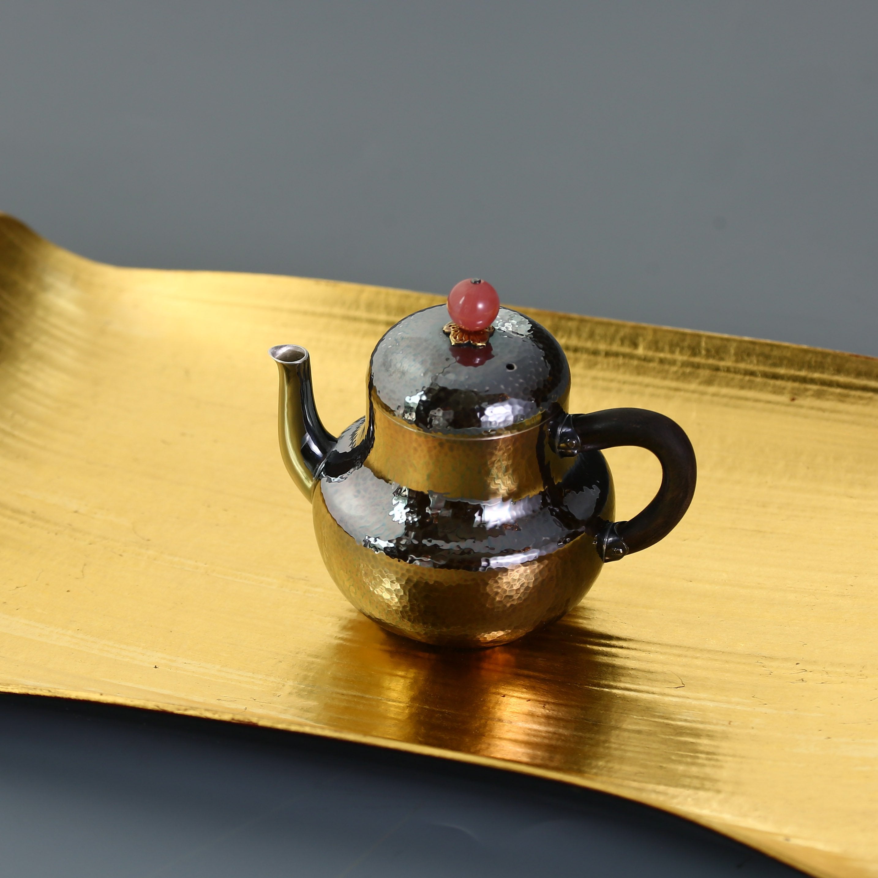 A pair of red-topped Siting sterling silver teapots