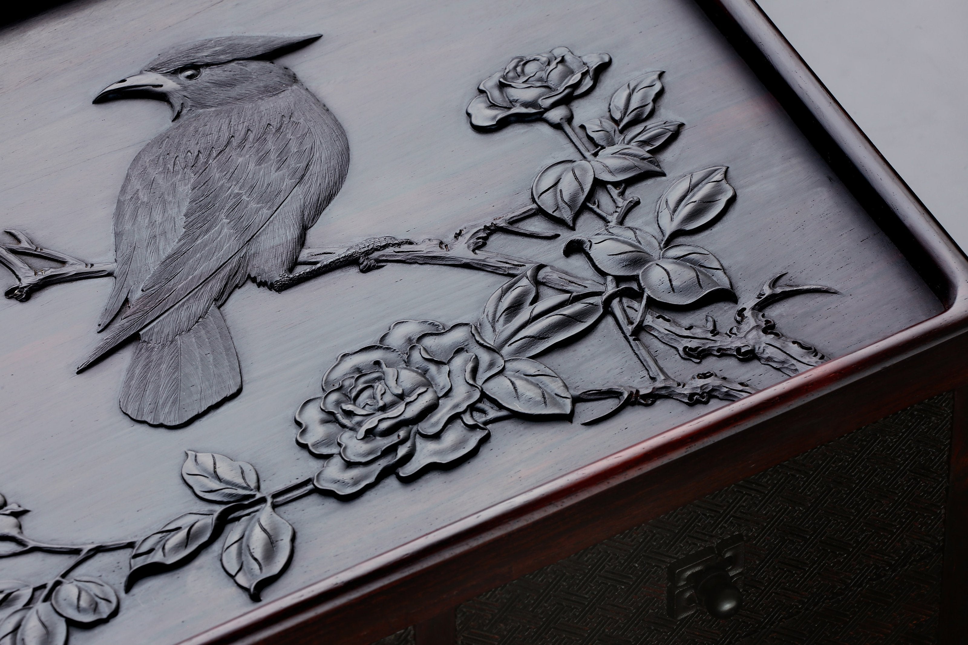 A four-drawer tea box carved from large-leaf sandalwood with silk feathers and hoopoe and swastika patterns.