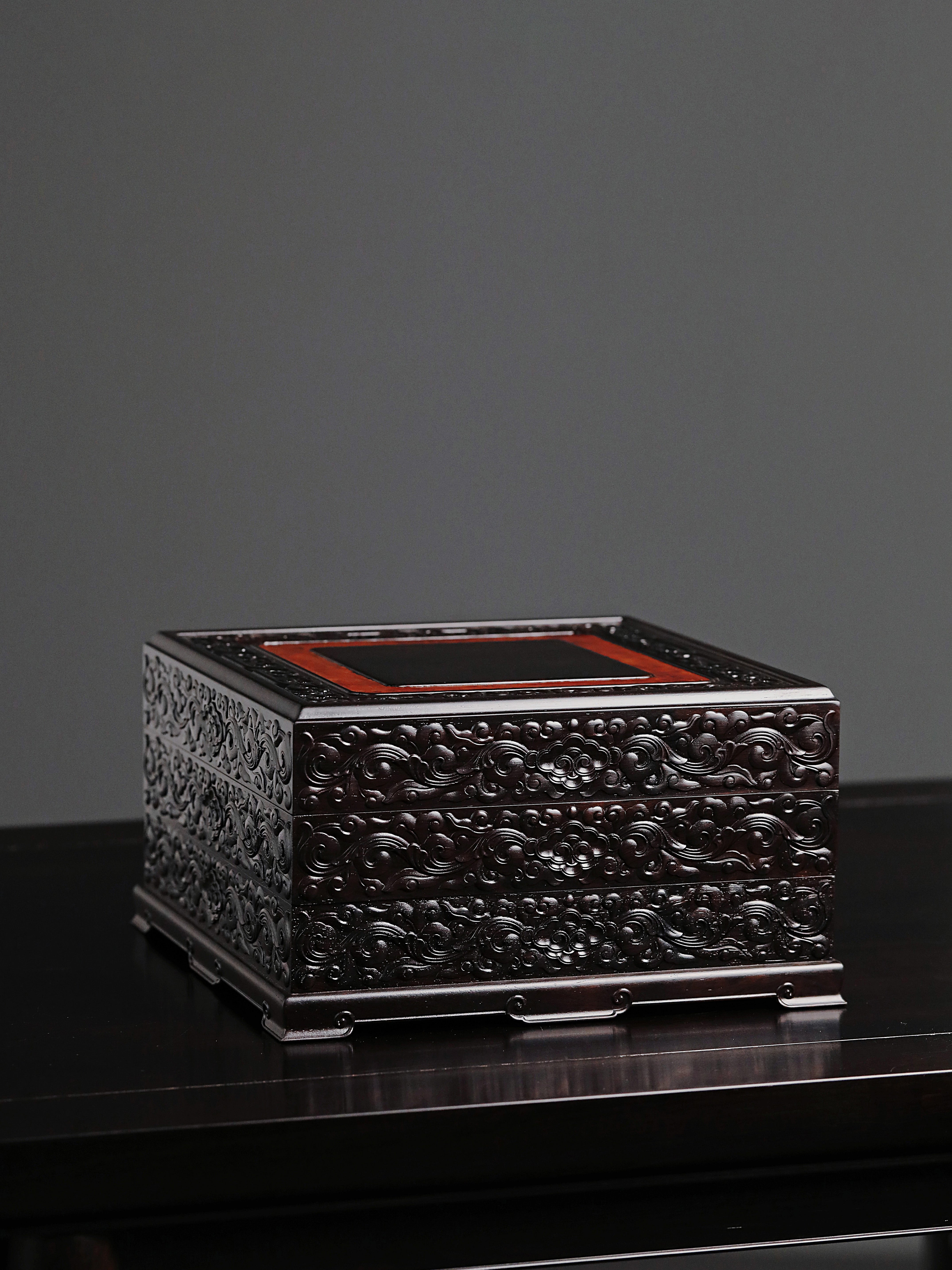Purple sandalwood tea box with auspicious cloud and scroll patterns, three-tiered lid and four corners.