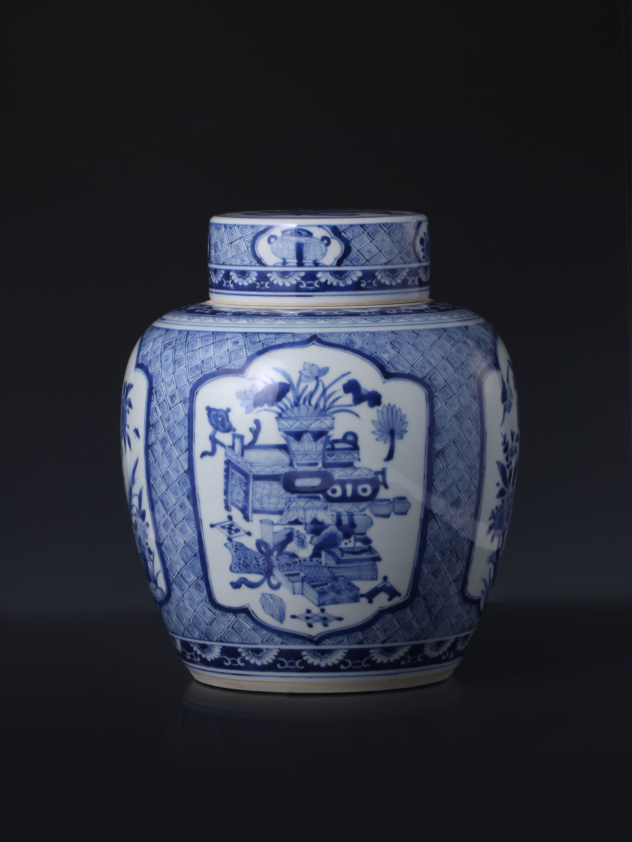 Kangxi blue and white porcelain tea caddy with four openwork panels depicting antique flowers and birds.