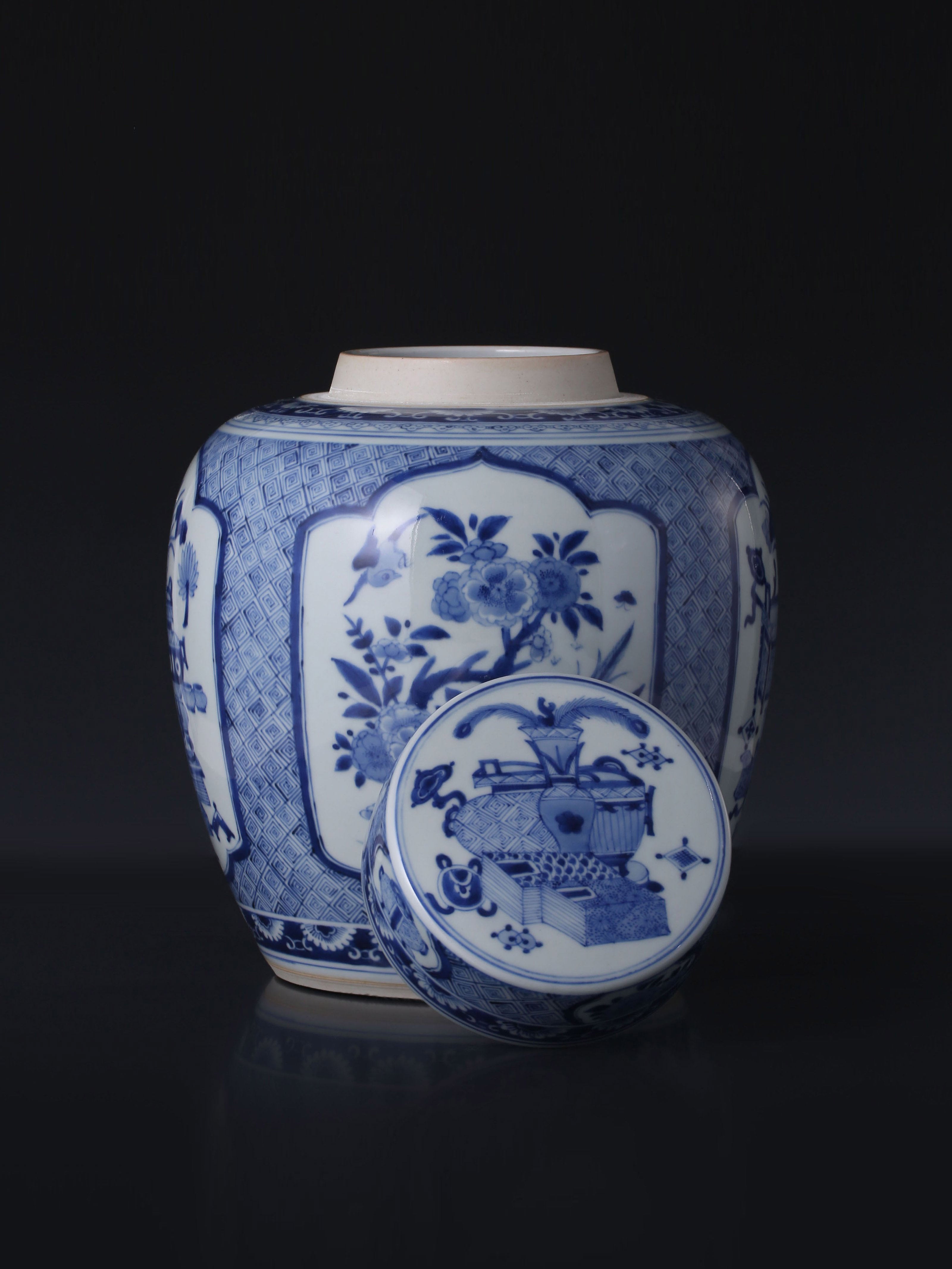 Kangxi blue and white porcelain tea caddy with four openwork panels depicting antique flowers and birds.
