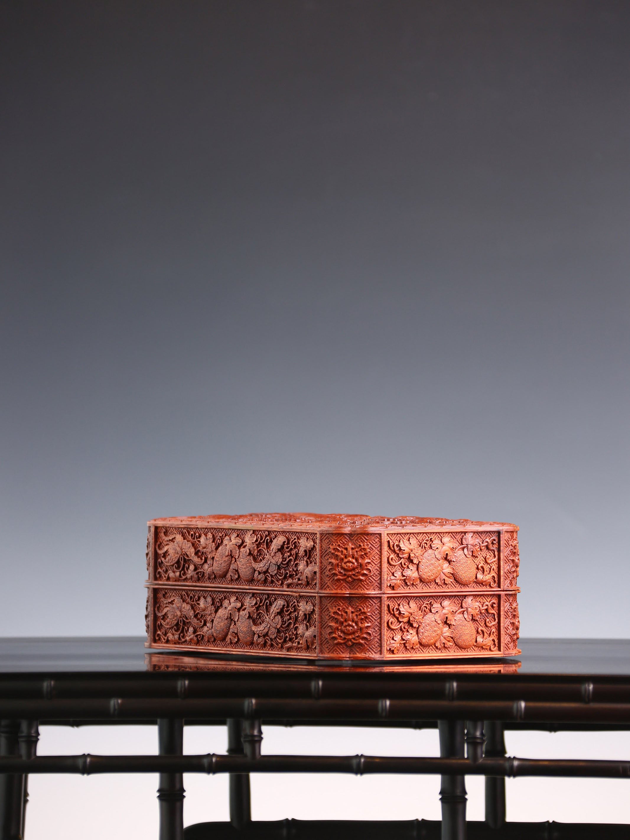 Tea box with full carving of lychee, butterfly, and dragon patterns