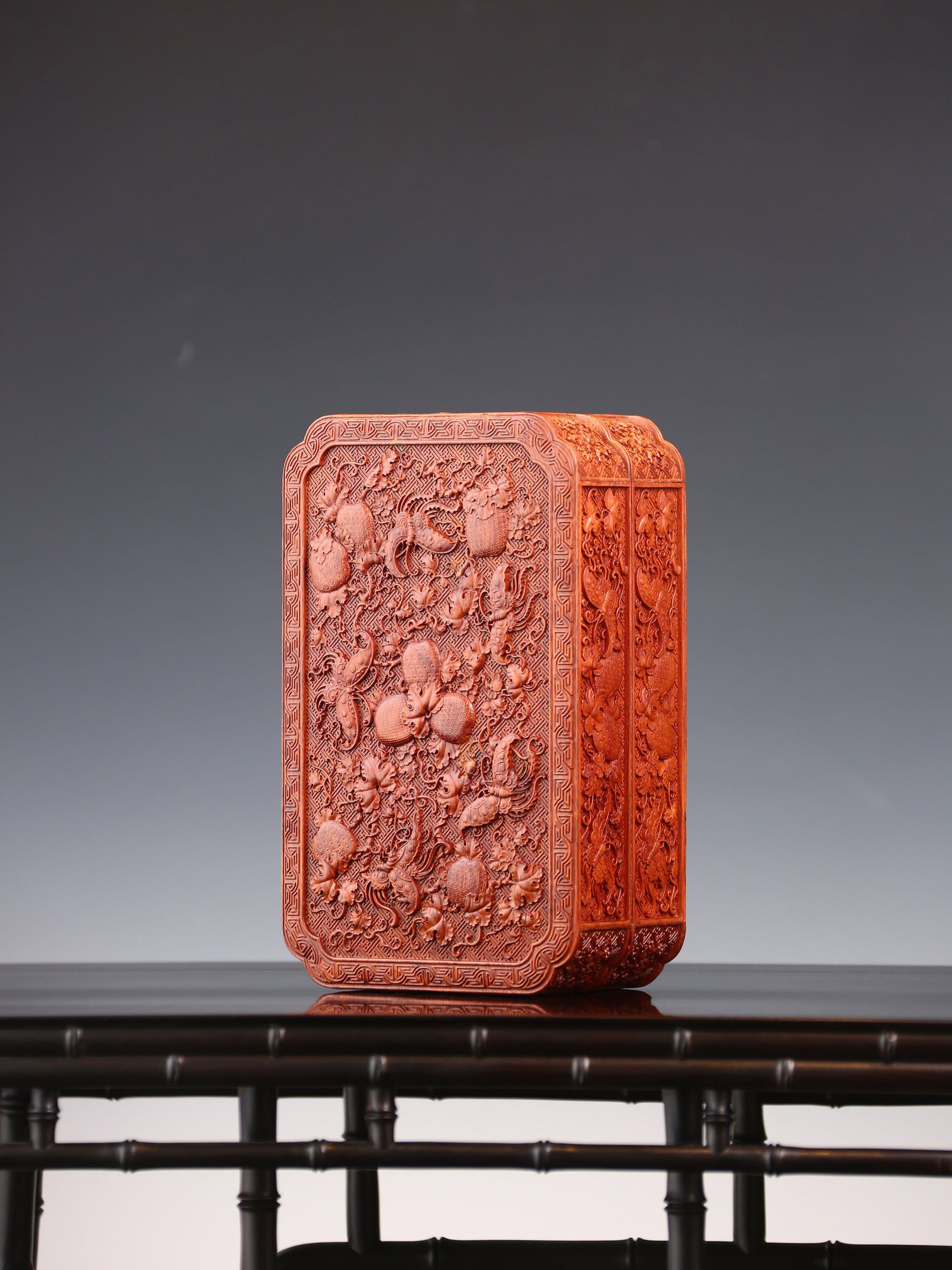 Tea box with full carving of lychee, butterfly, and dragon patterns