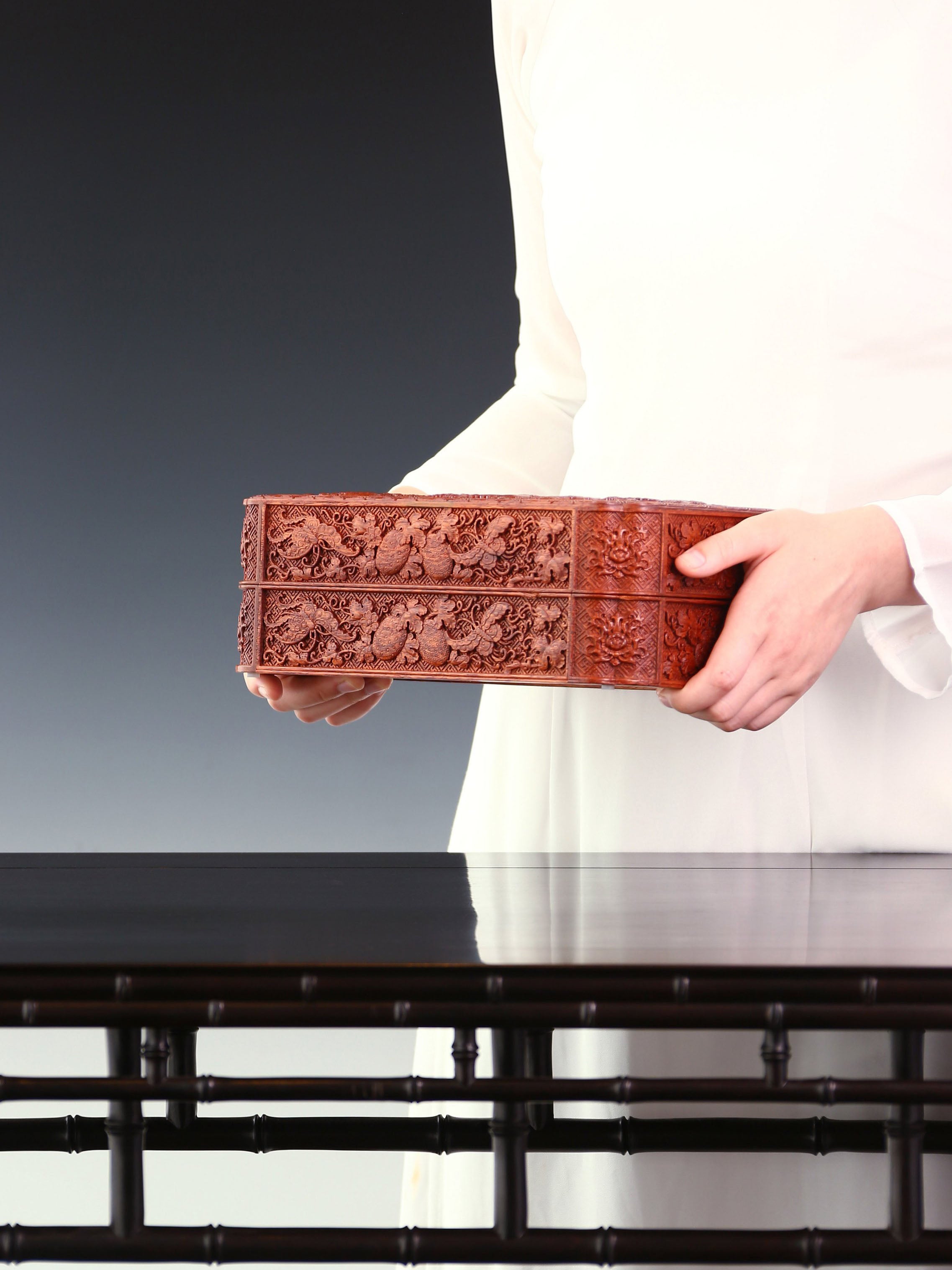 Tea box with full carving of lychee, butterfly, and dragon patterns