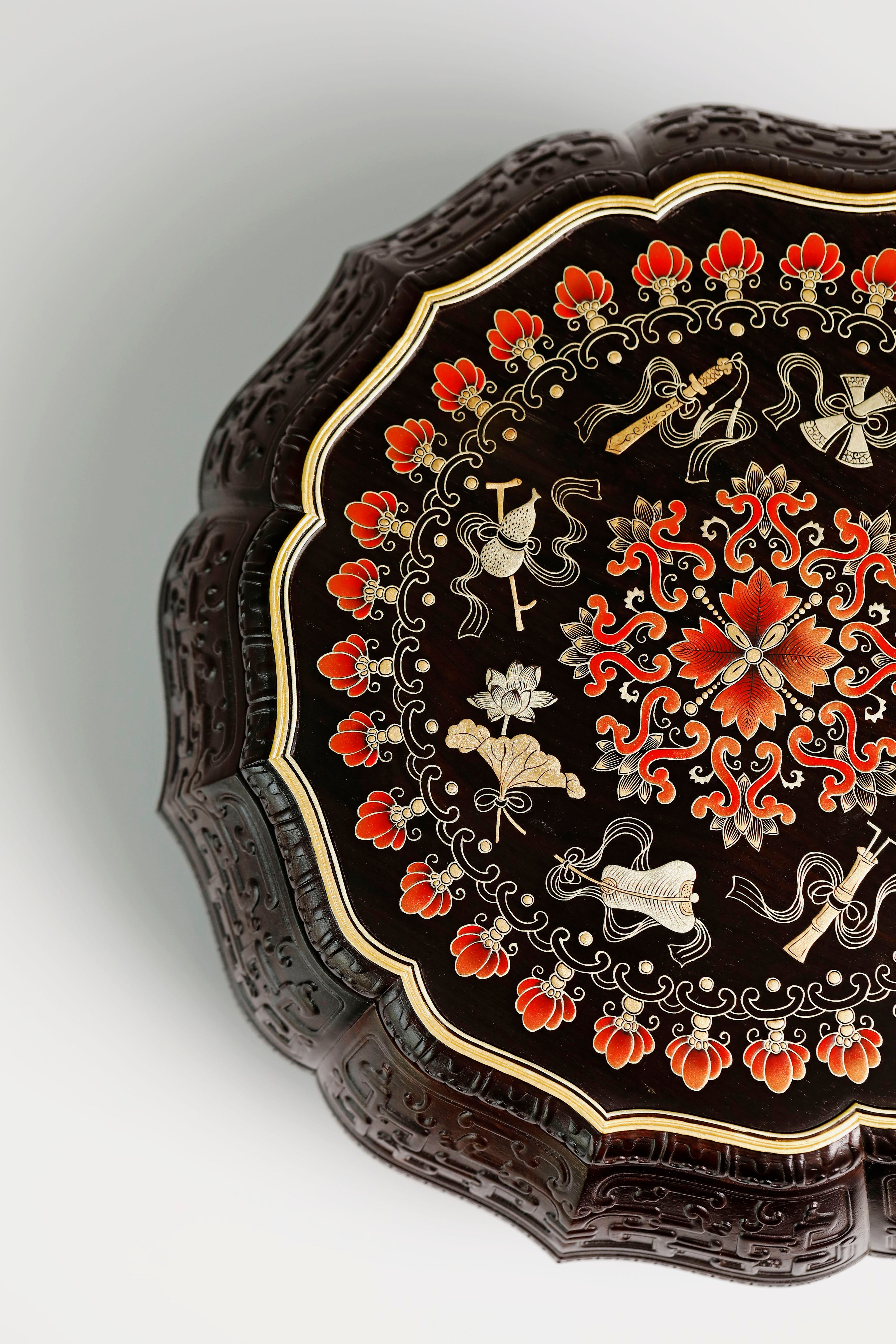 Purple sandalwood twelve-cornered fruit box with gilded Eight Immortals design and sunflower-shaped opening.