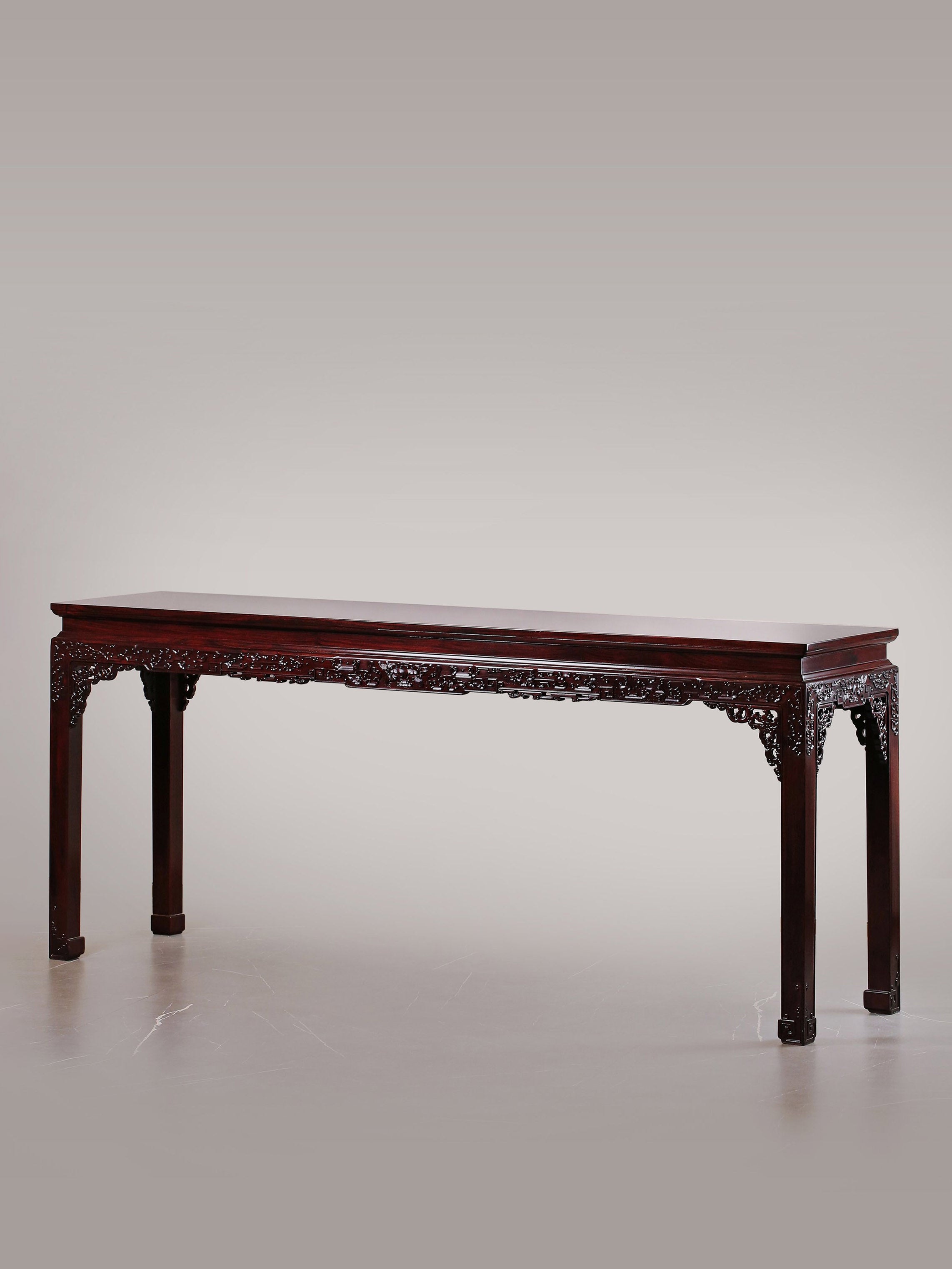 A large rosewood table with taotie design, made for the Qing Dynasty imperial court.