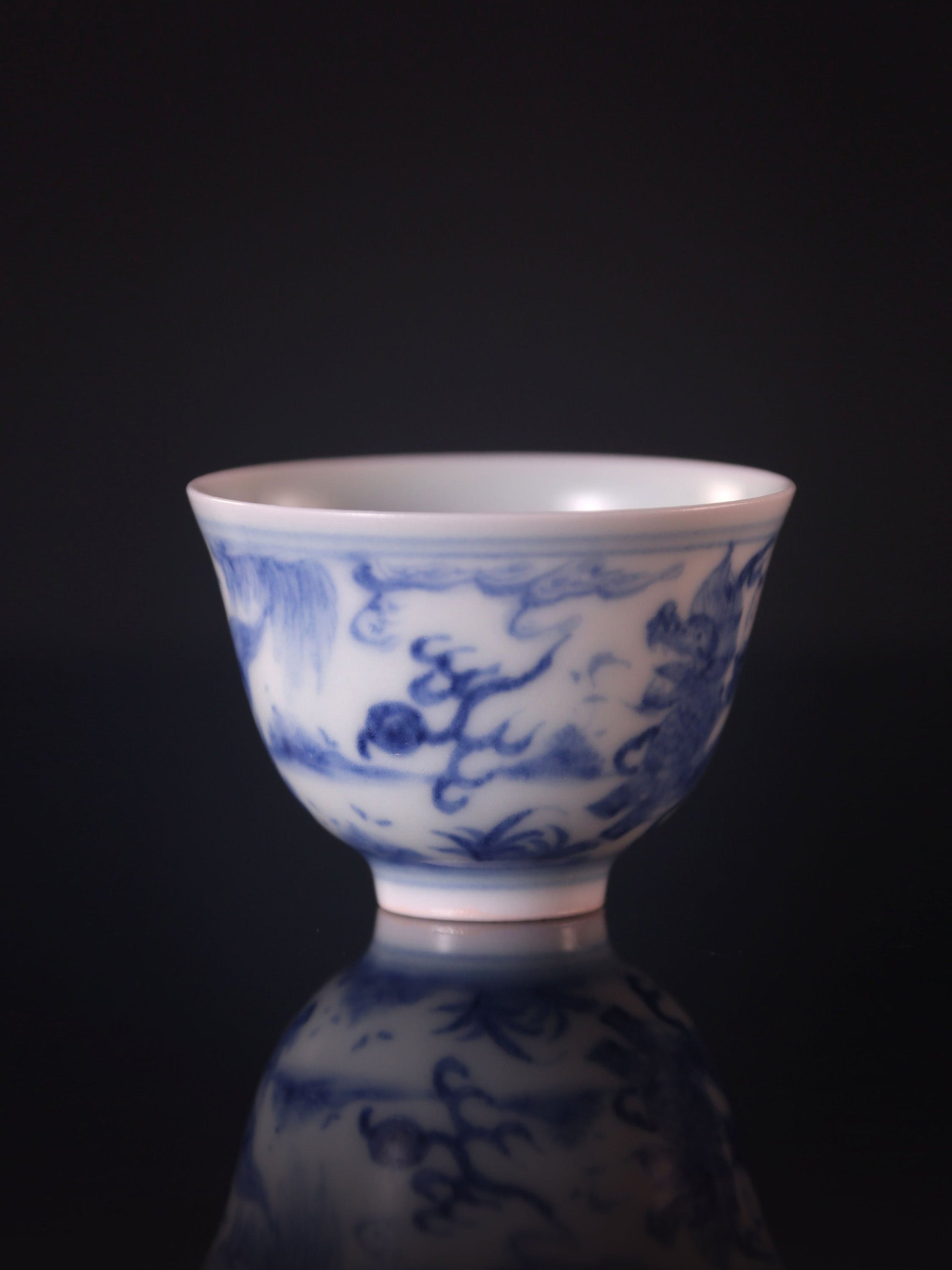Blue and white porcelain cup with a unicorn and a child