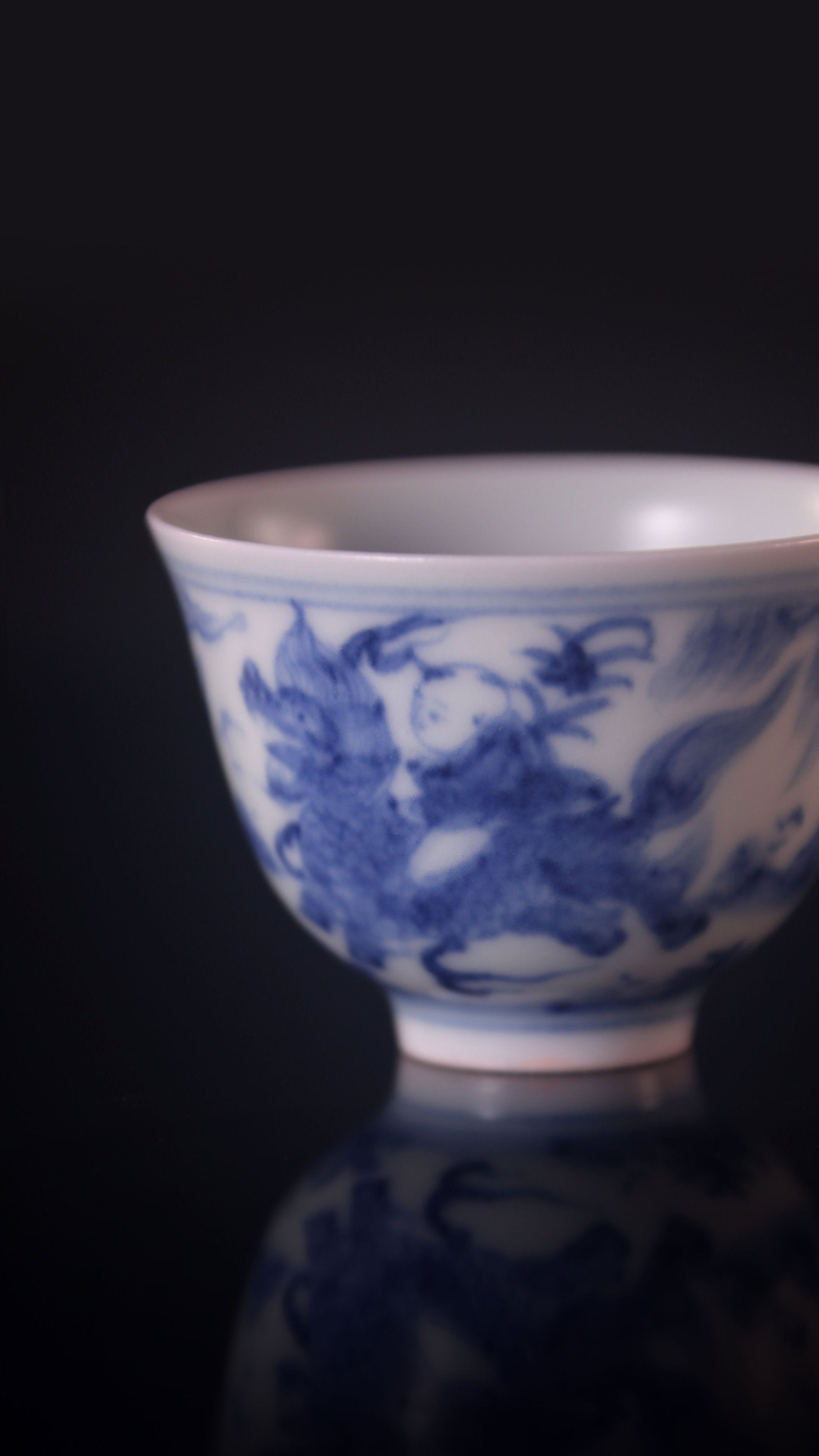 Blue and white porcelain cup with a unicorn and a child