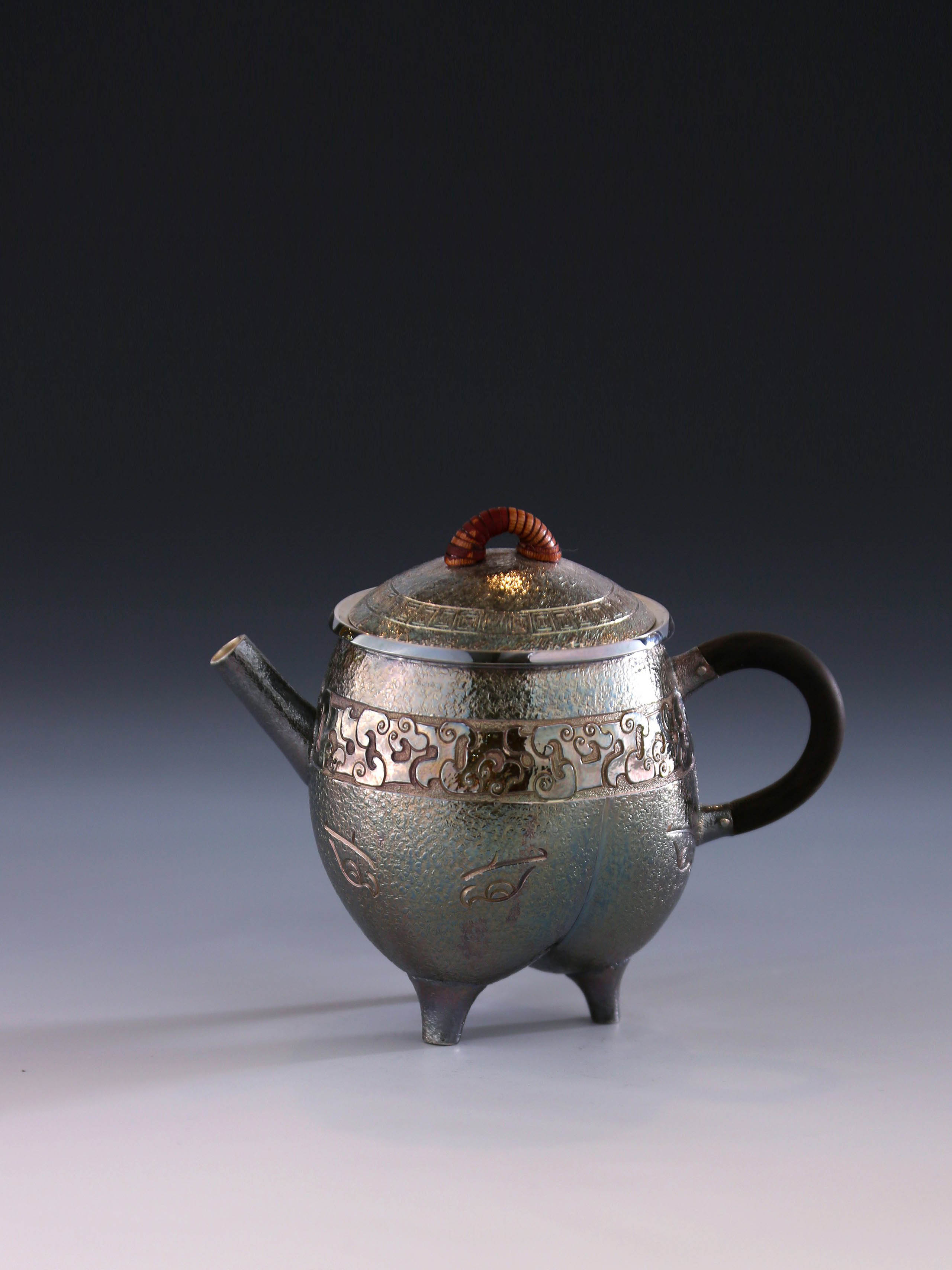 Three-legged tripod with animal motifs