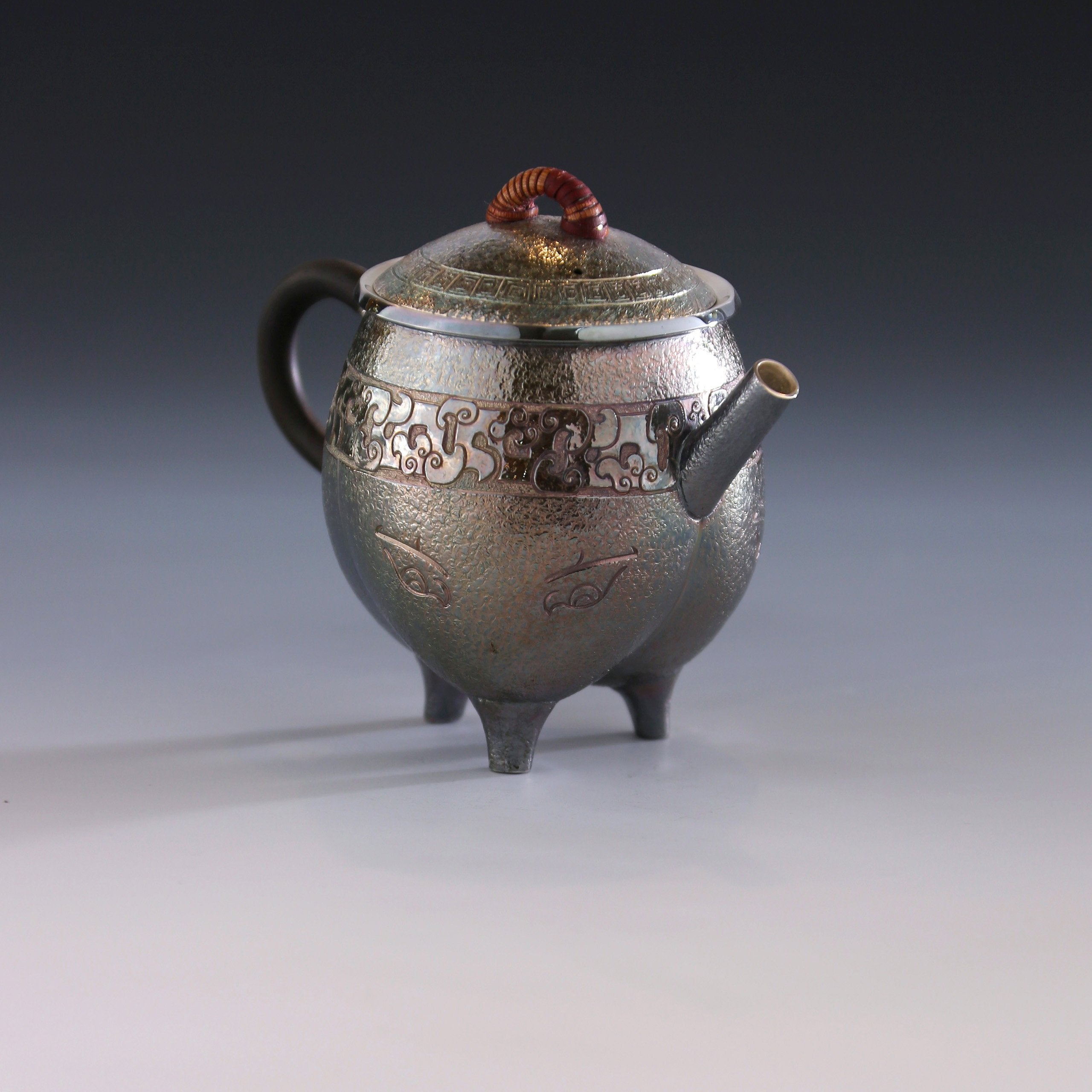 Three-legged tripod with animal motifs