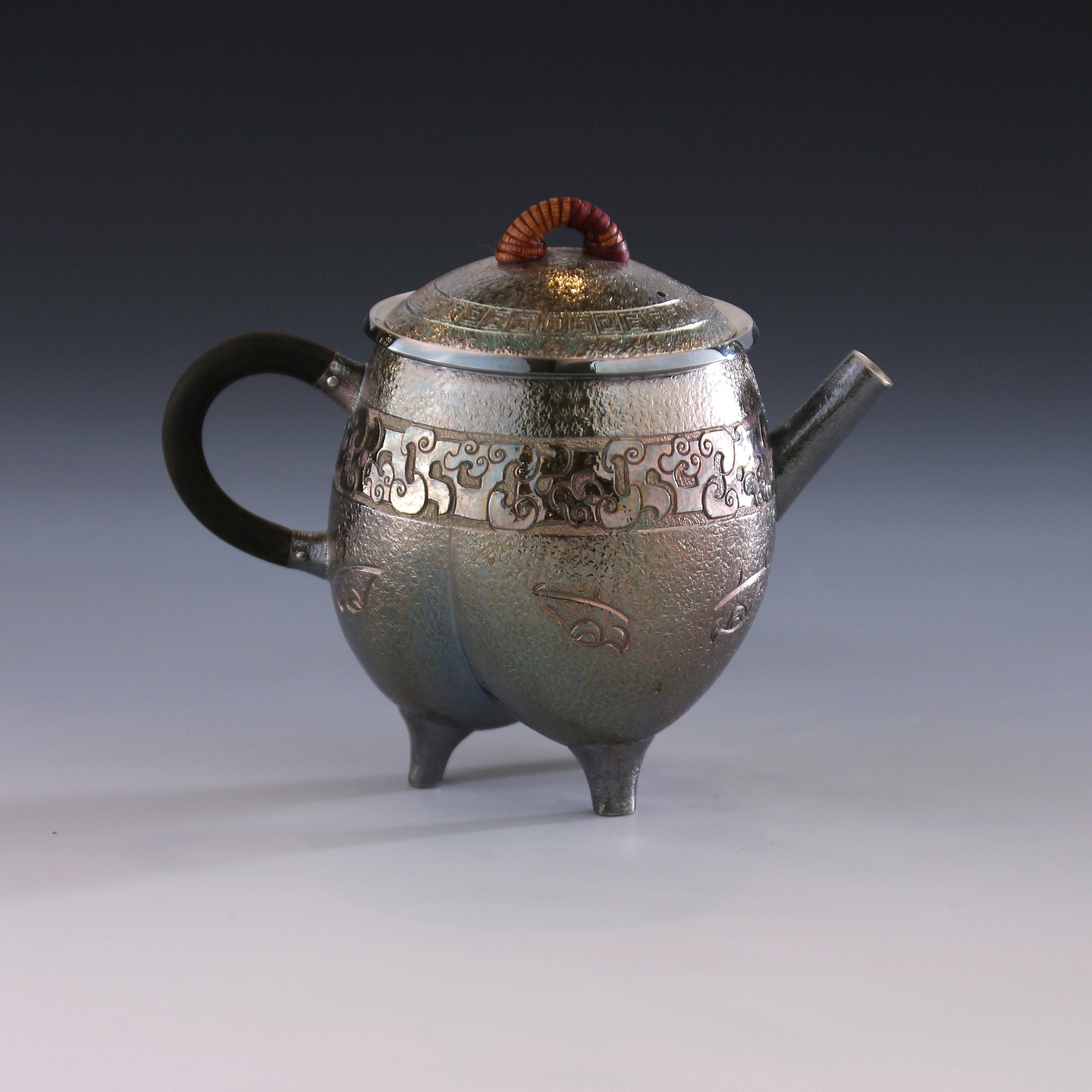 Three-legged tripod with animal motifs