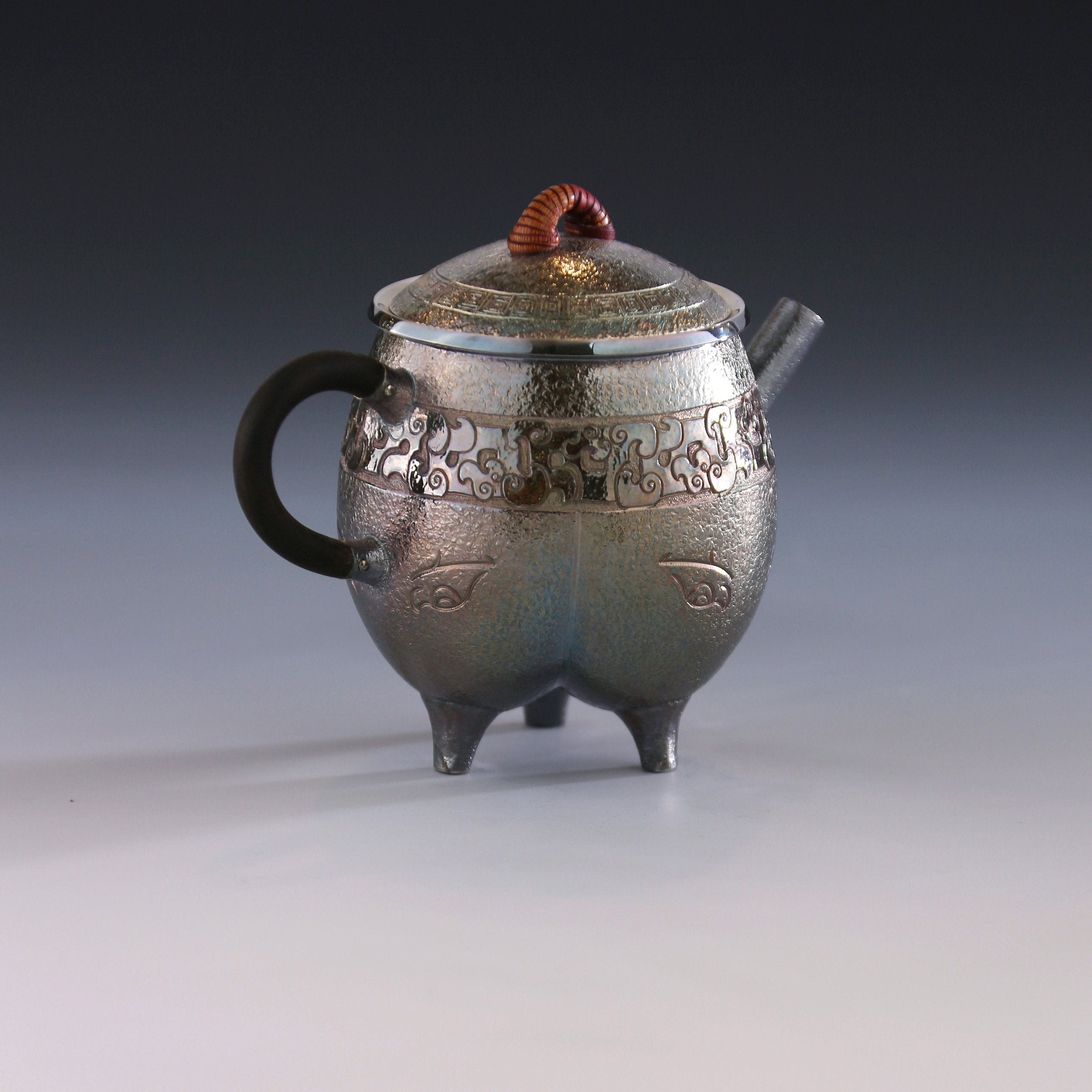 Three-legged tripod with animal motifs