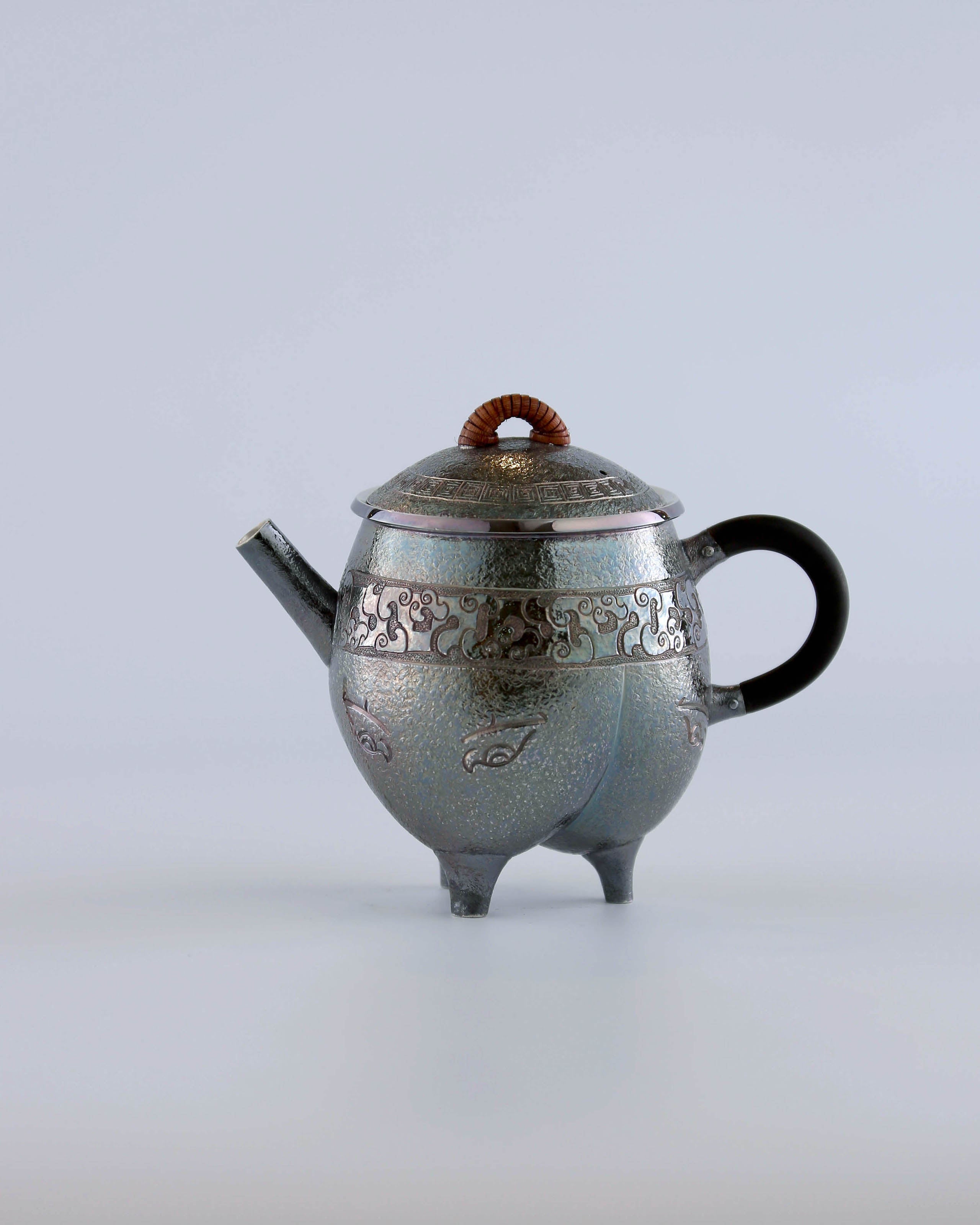 Three-legged tripod with animal motifs