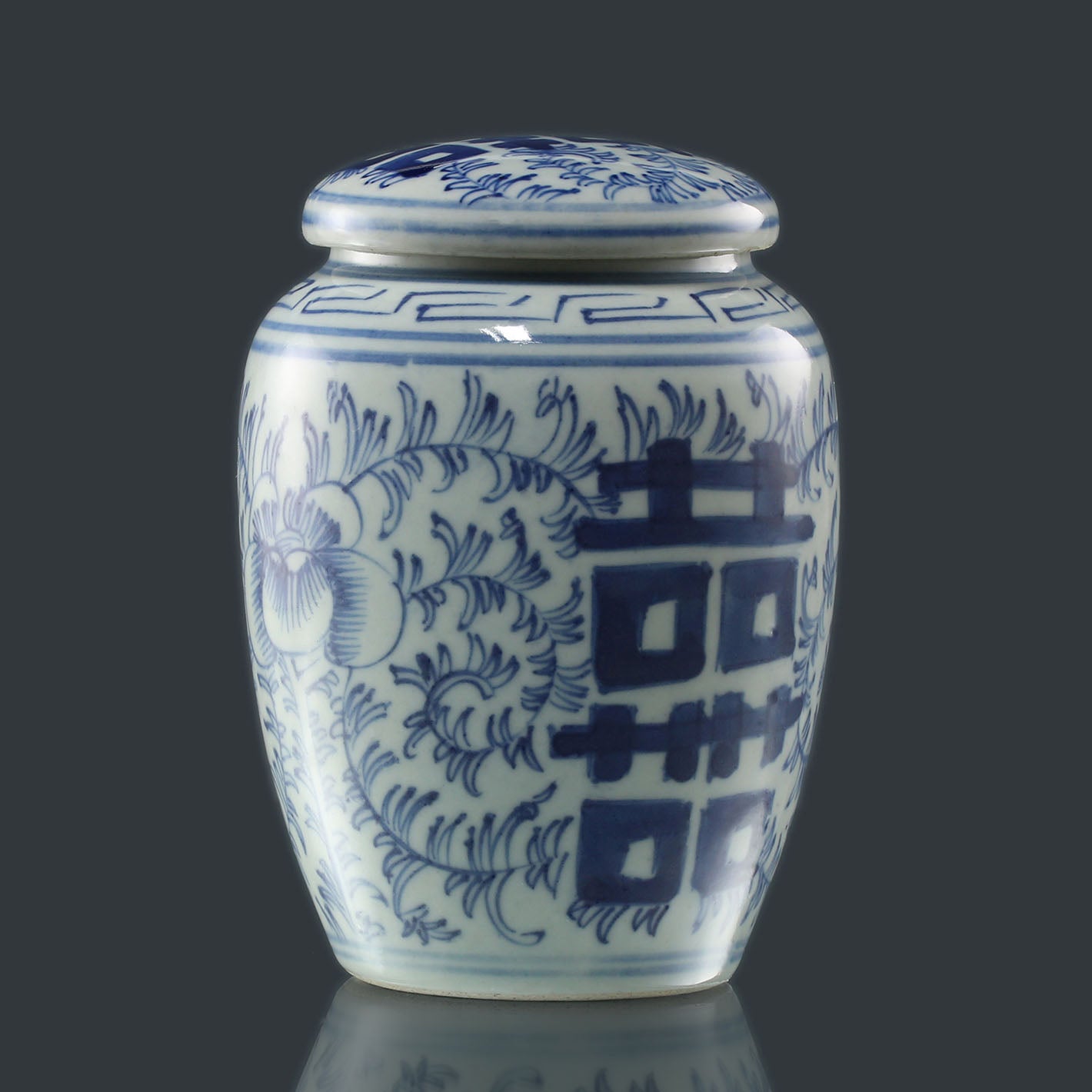 Blue and white porcelain tea canister with auspicious floral patterns