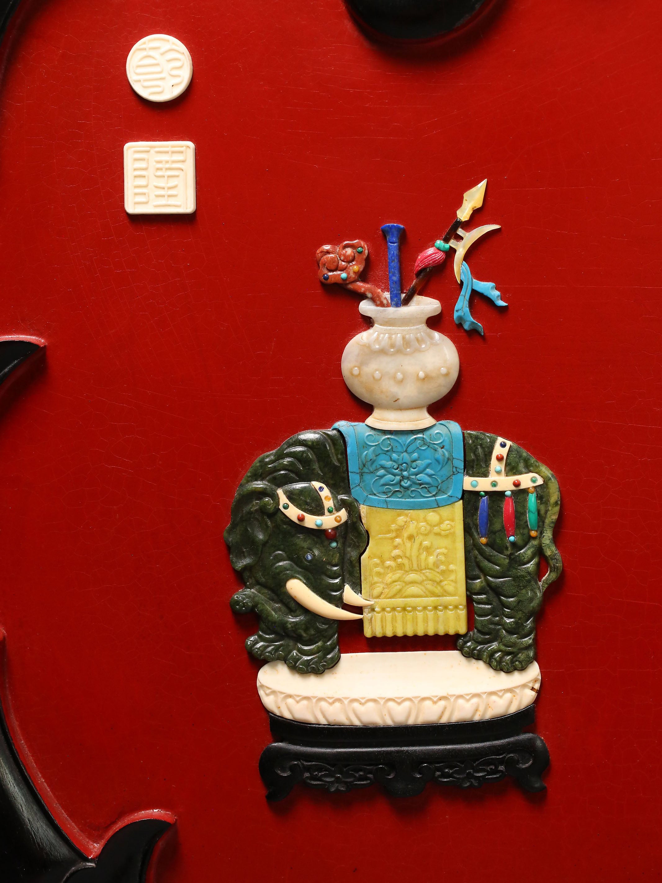 A hanging screen inlaid with precious stones, symbolizing peace and prosperity.