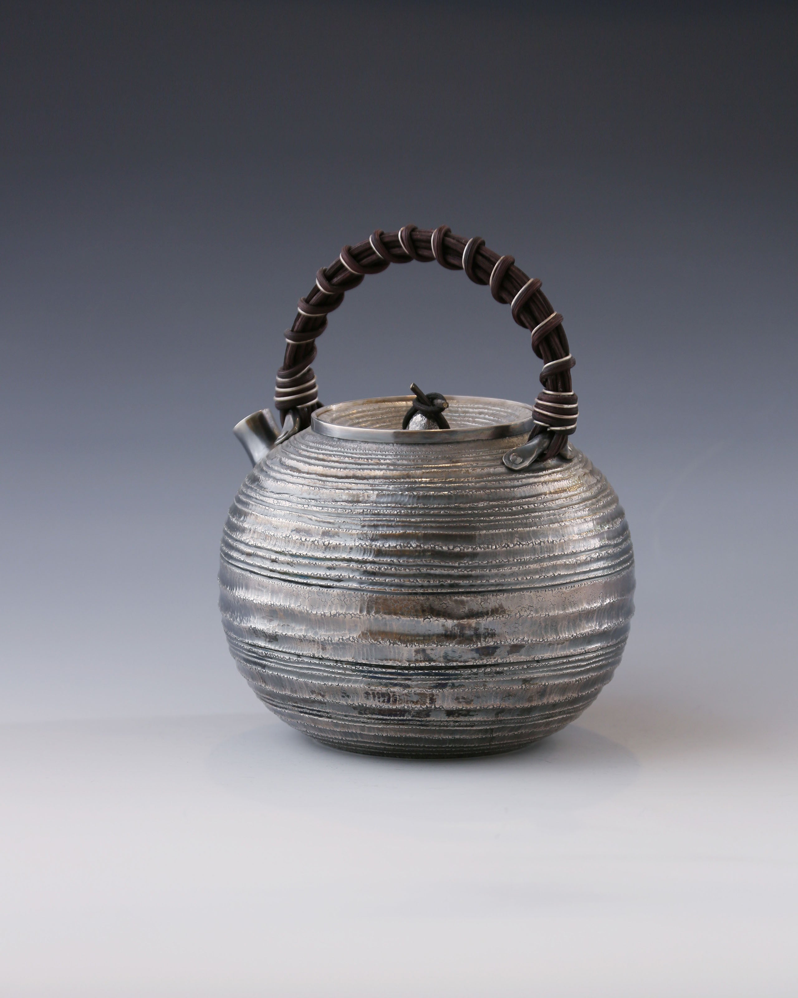 Purple Silver Teapot with Wicker Handle and Swirling Pattern