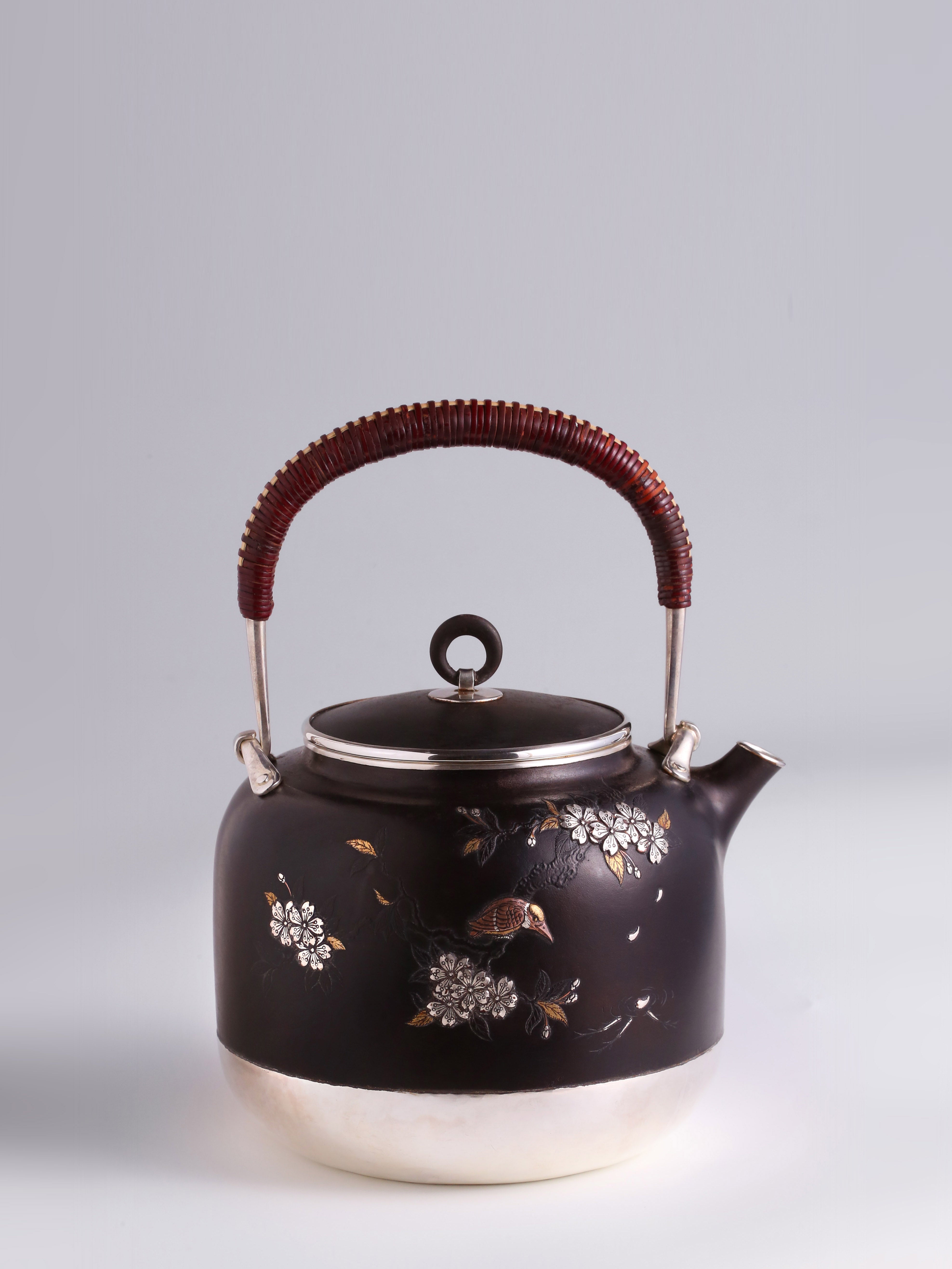 Iron-clad silver flower and bird inlaid gold and silver teapot