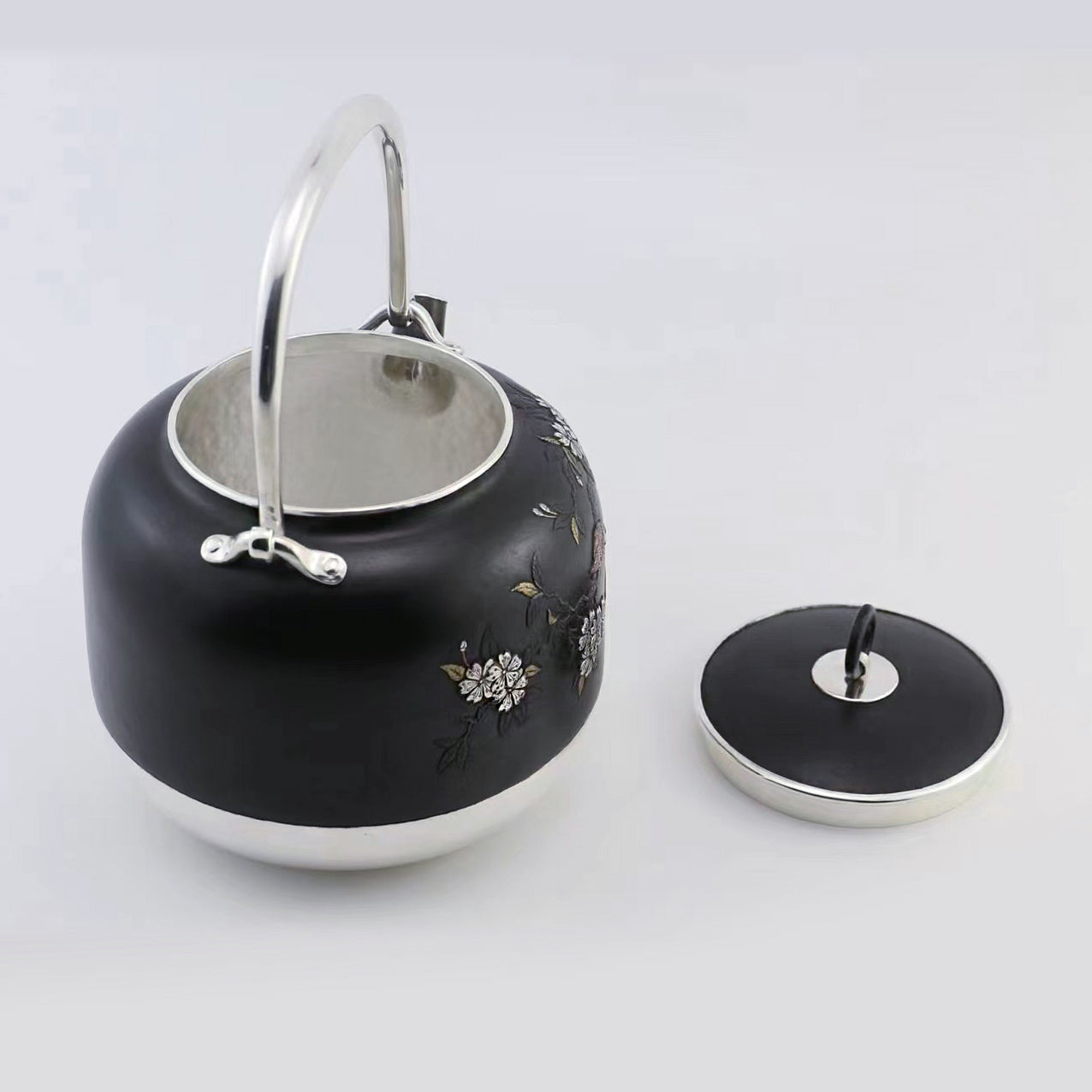 Iron-clad silver flower and bird inlaid gold and silver teapot