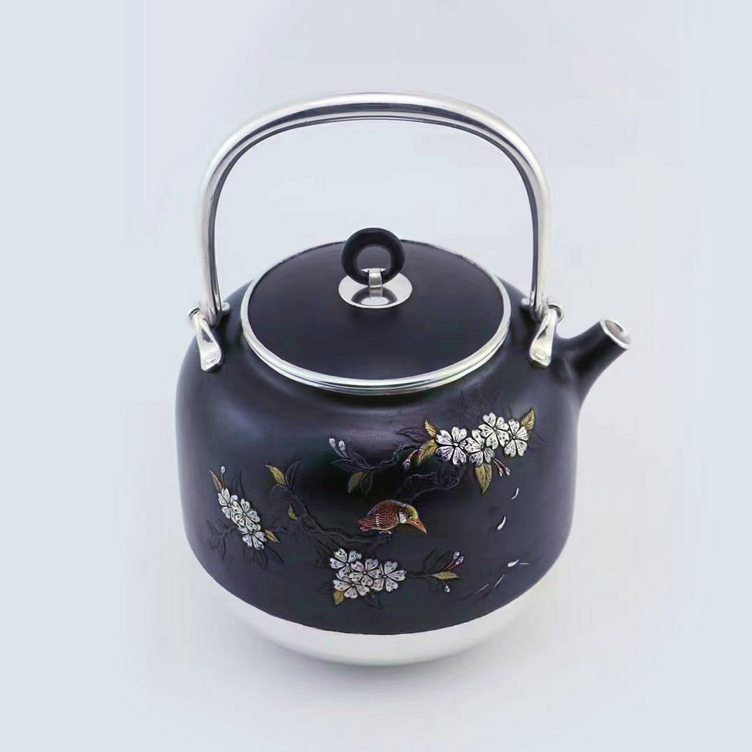 Iron-clad silver flower and bird inlaid gold and silver teapot