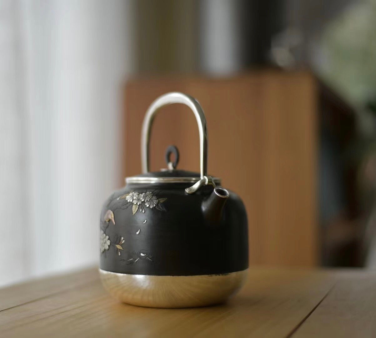 Iron-clad silver flower and bird inlaid gold and silver teapot