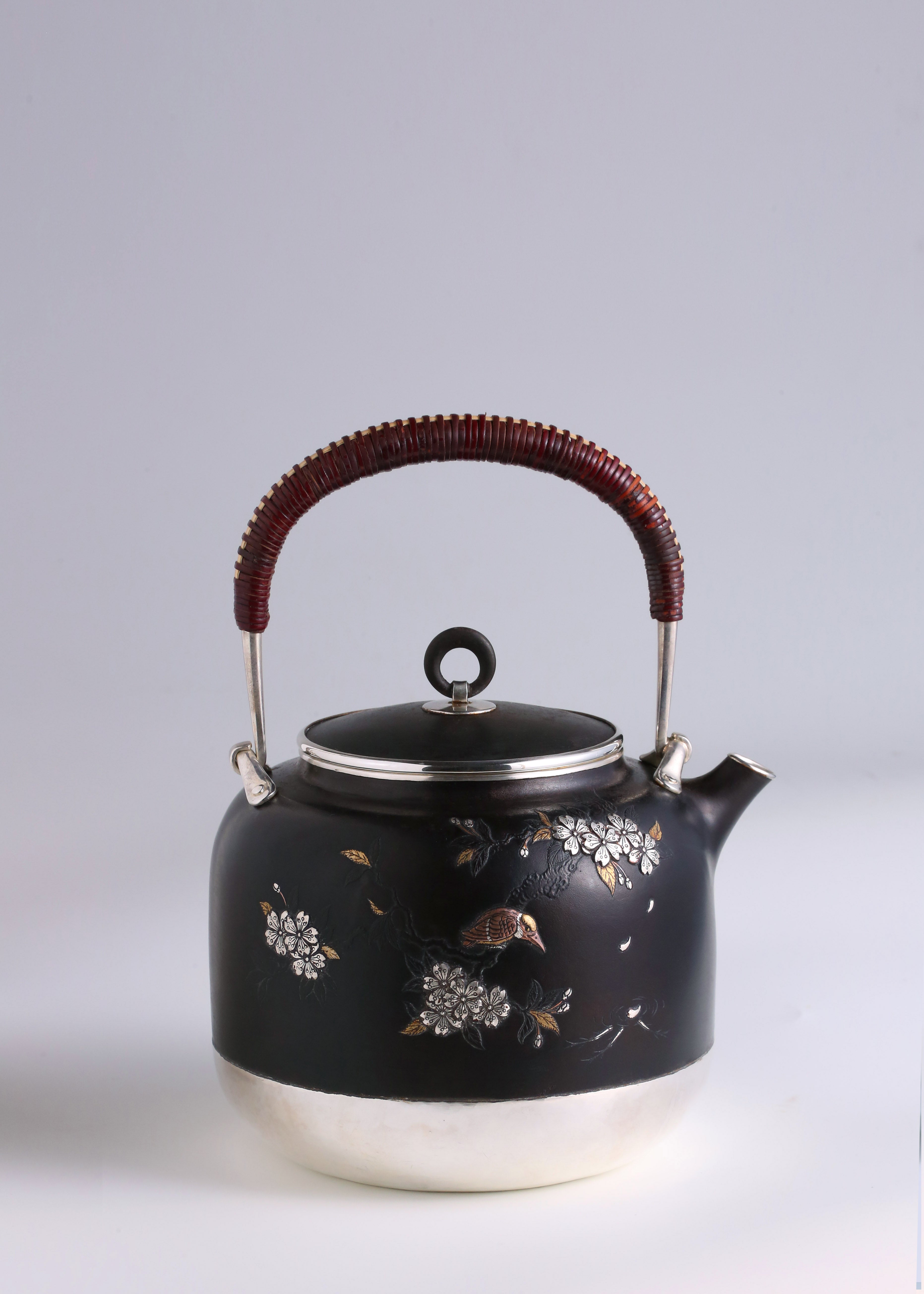 Iron-clad silver flower and bird inlaid gold and silver teapot