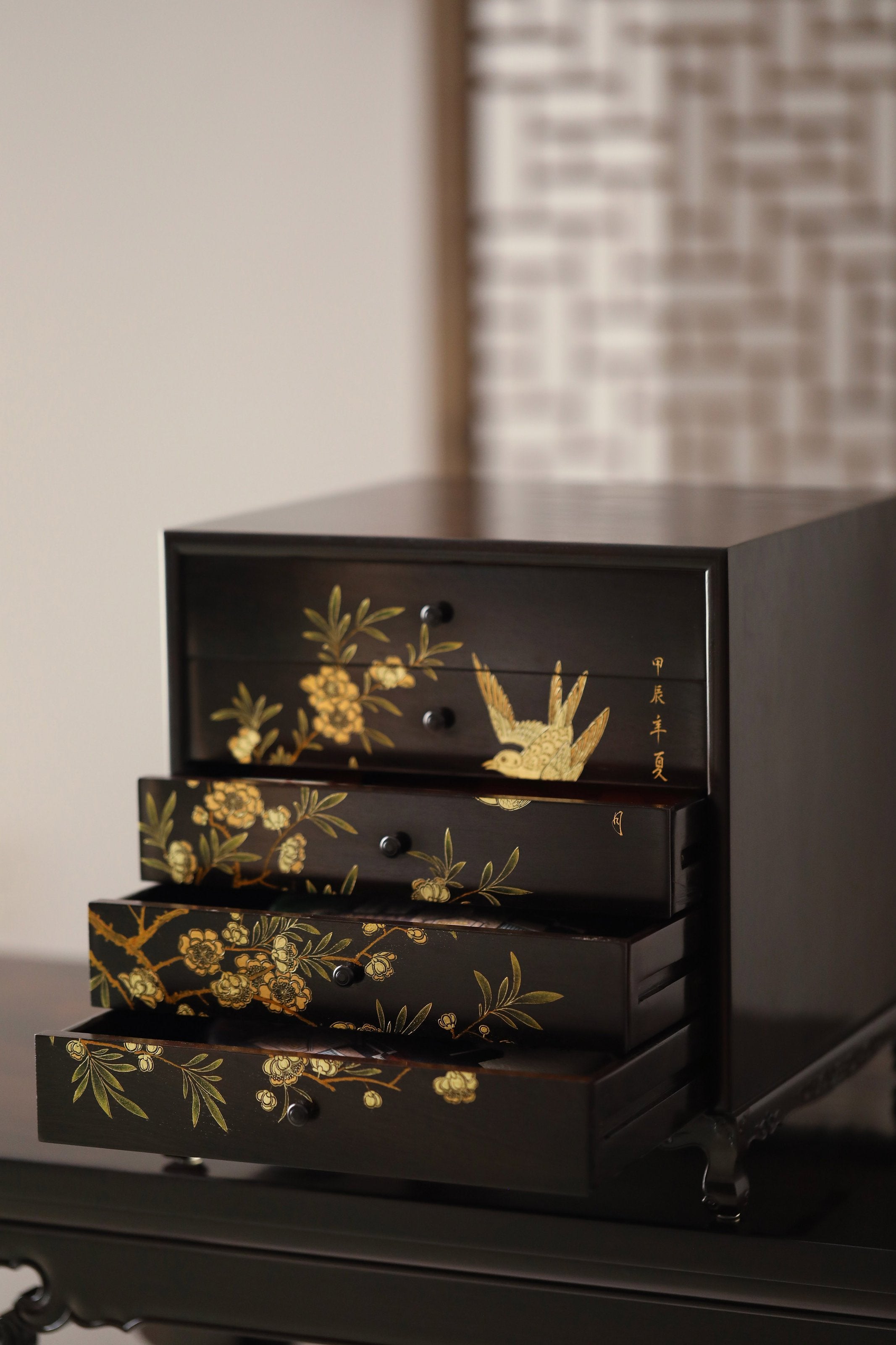 Gold piled high, joy on eyebrows / Wealth and good fortune on the table, five cups of tea on the sideboard