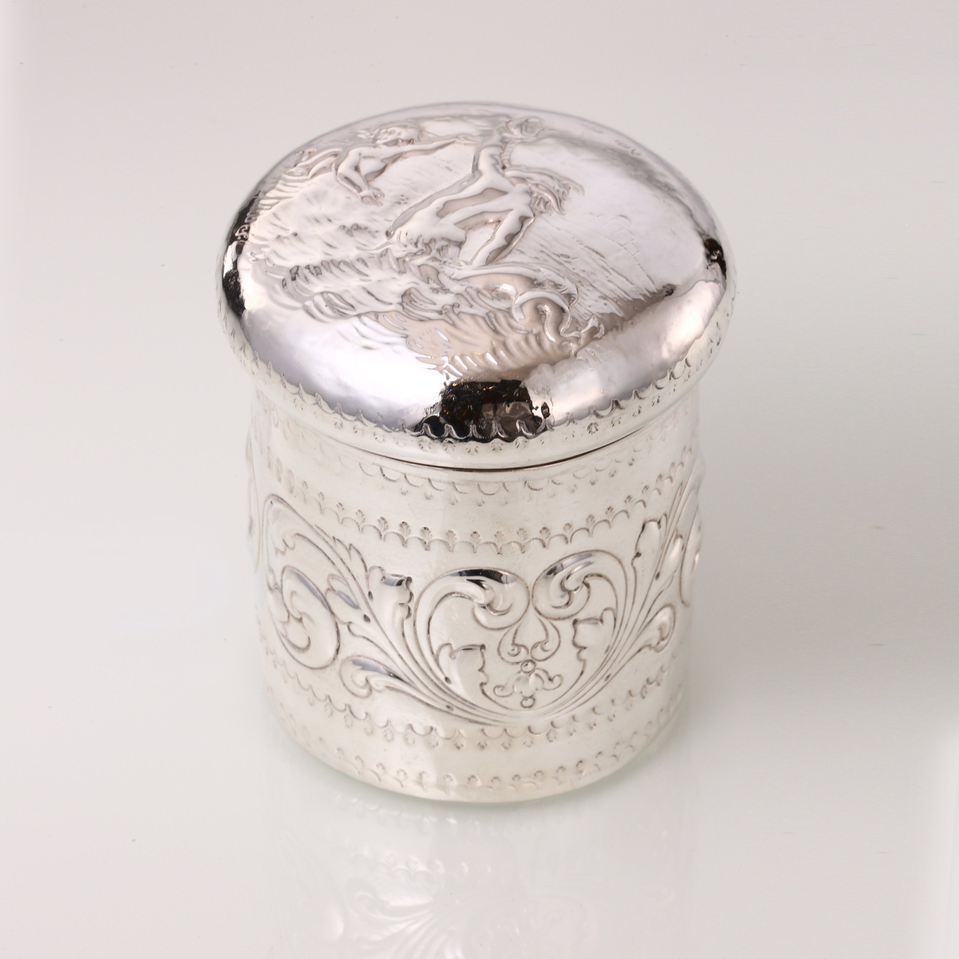 1884 British sterling silver tea caddy with relief floral and figure design